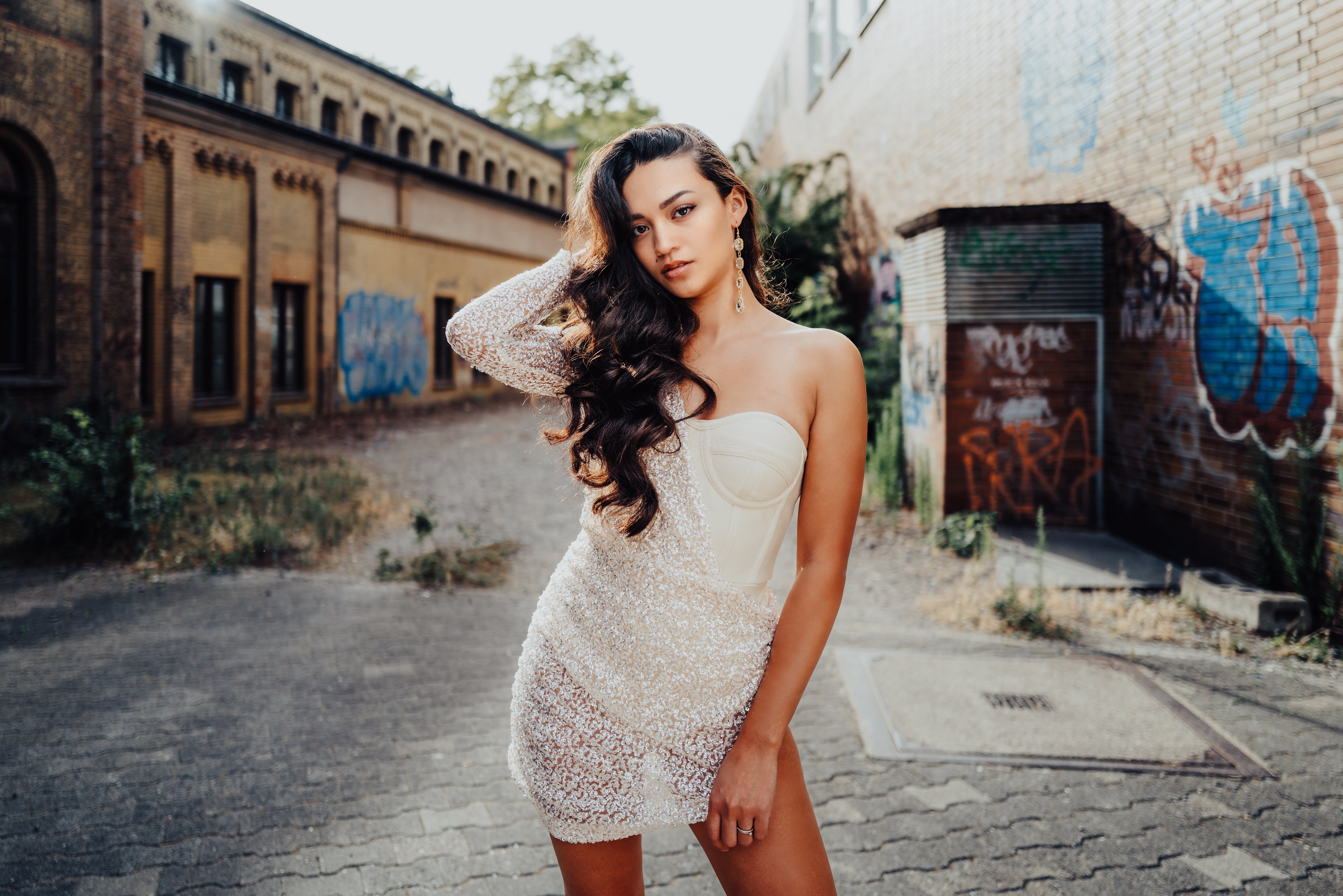 Woman in white dress in front of graffiti wall HD Wallpaper