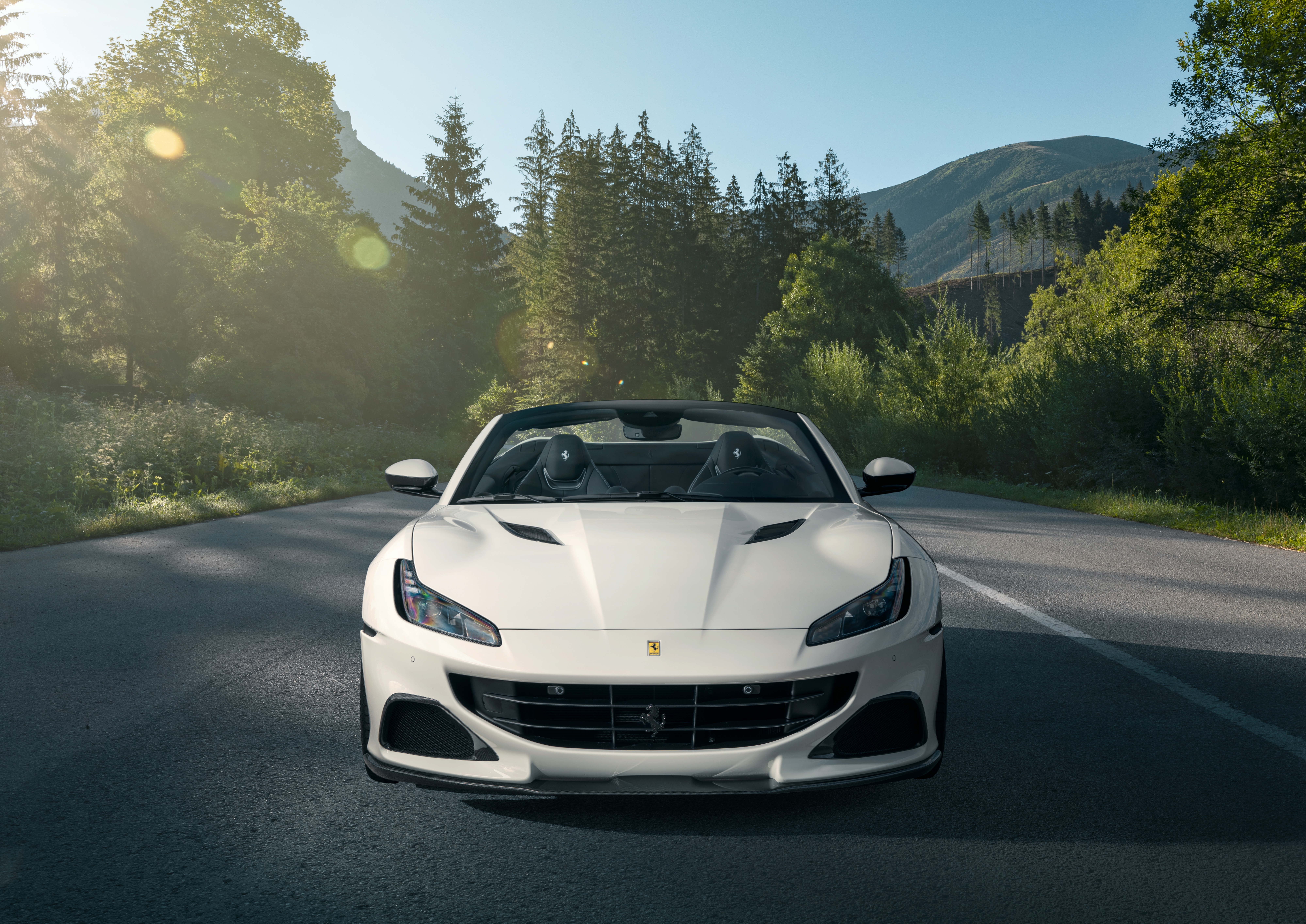 White Ferrari Portofino convertible on a mountain road HD Wallpaper
