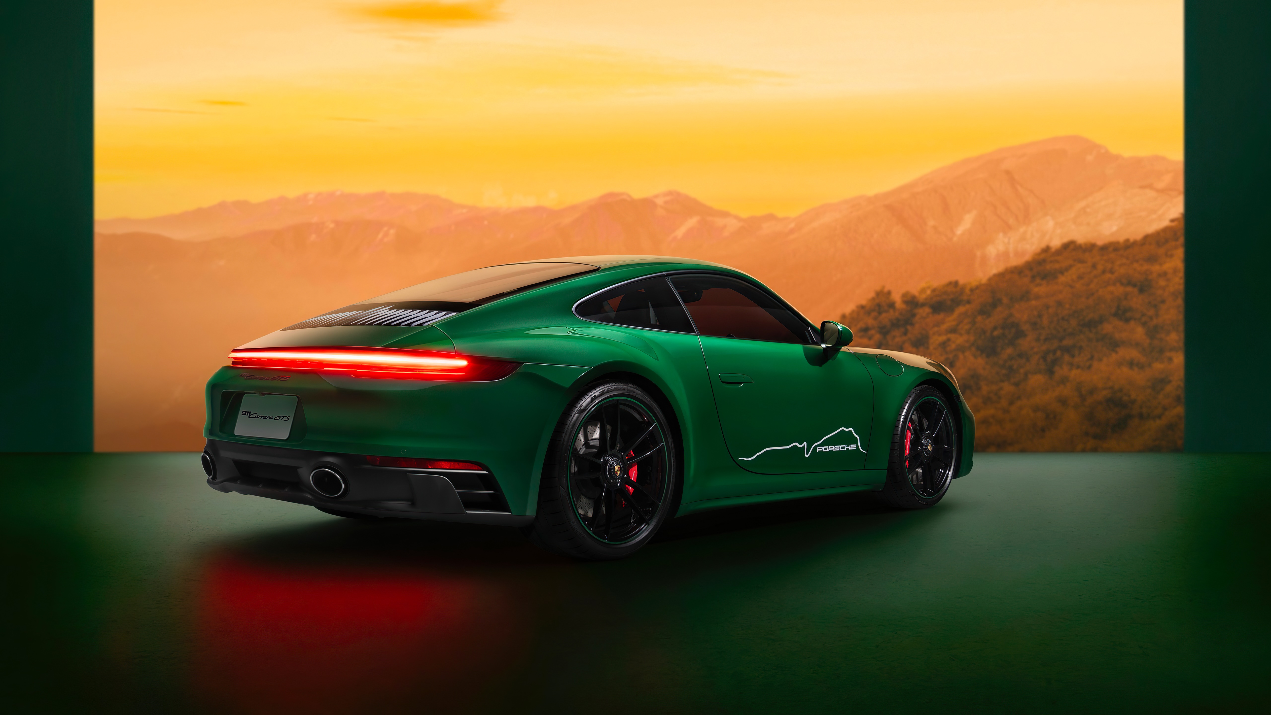 Green Porsche 911 Carrera GTS with mountain backdrop HD Wallpaper