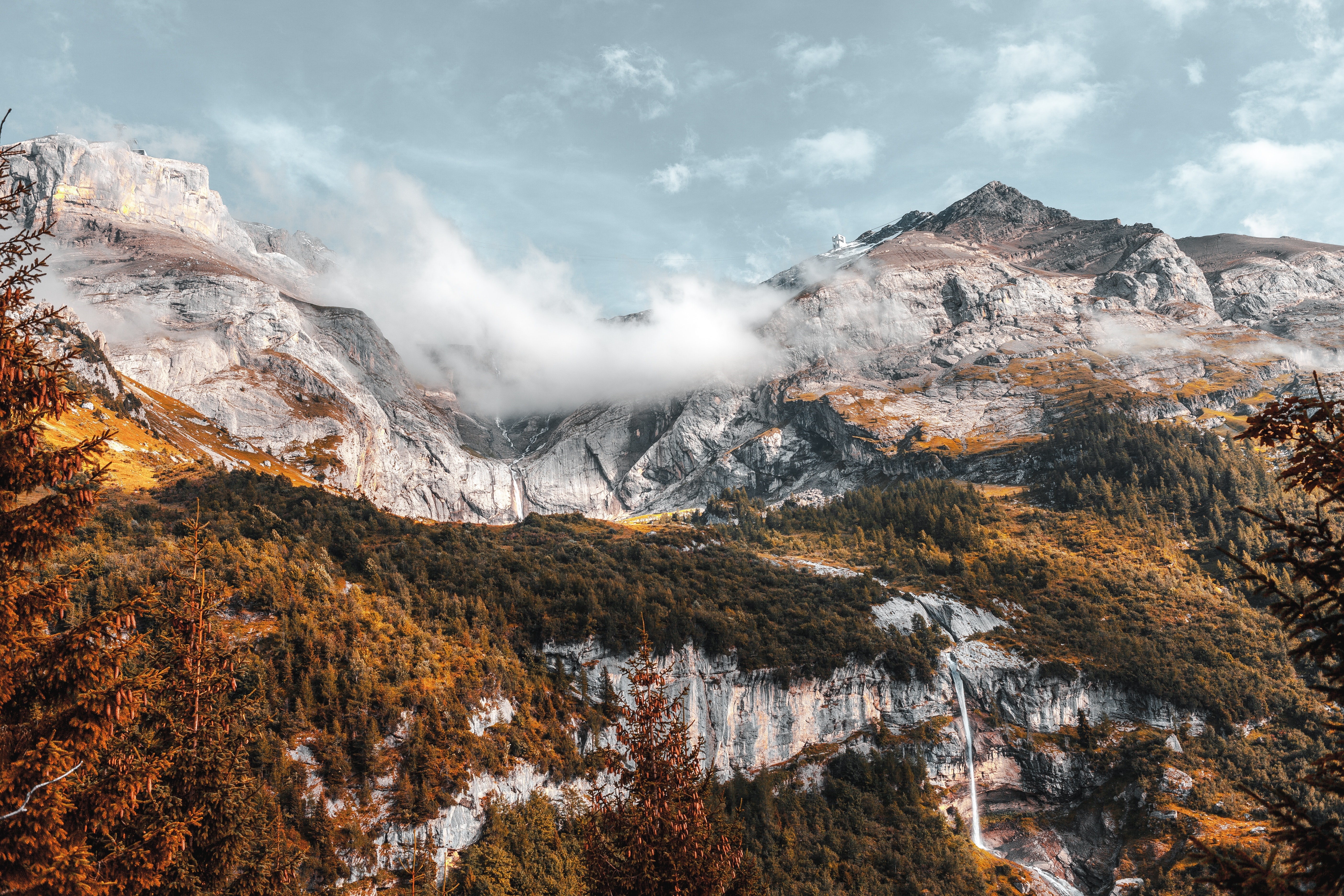 Majestic mountains with a waterfall and forest HD Wallpaper