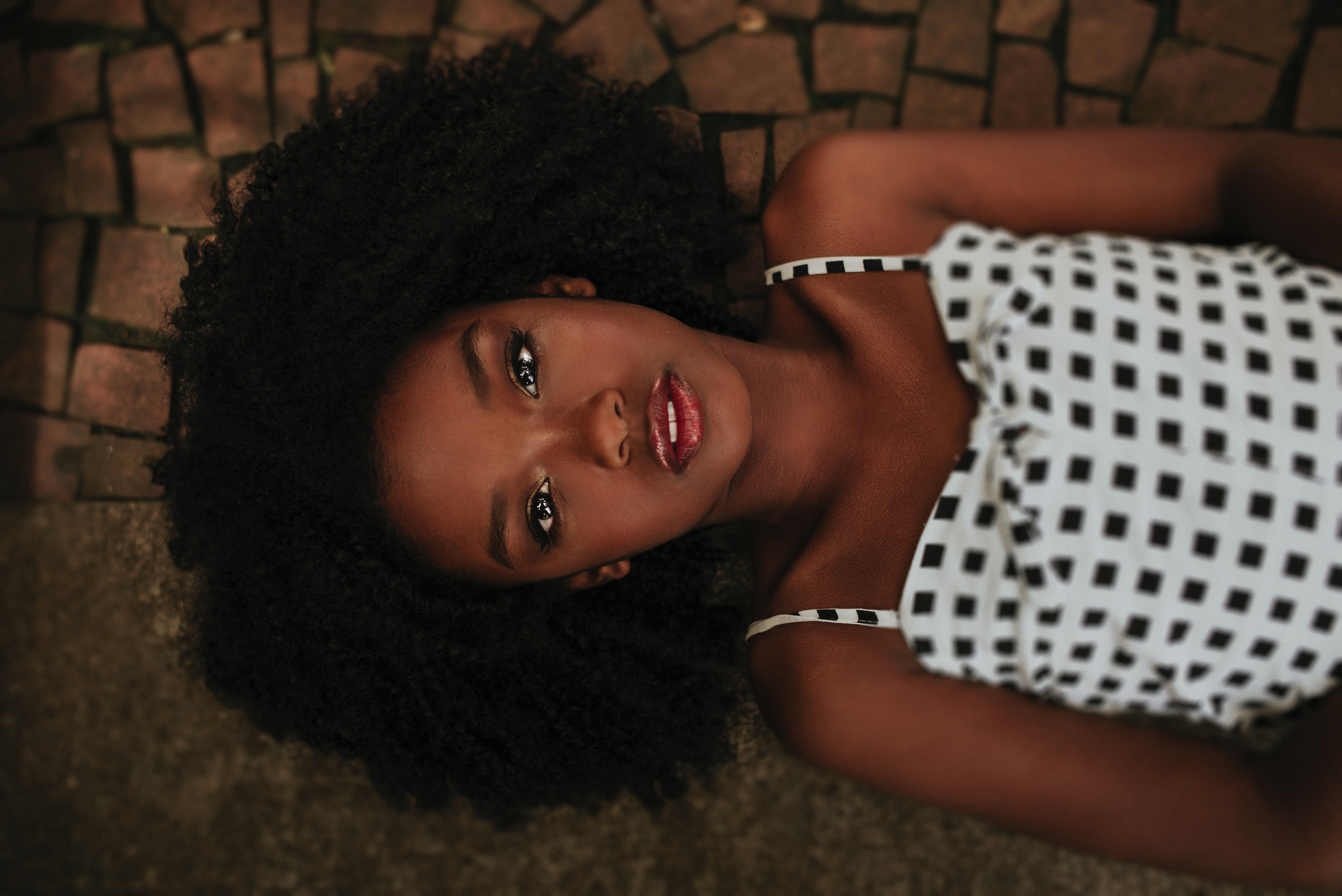 Model Lying Down with Black Curly Hair HD Wallpaper