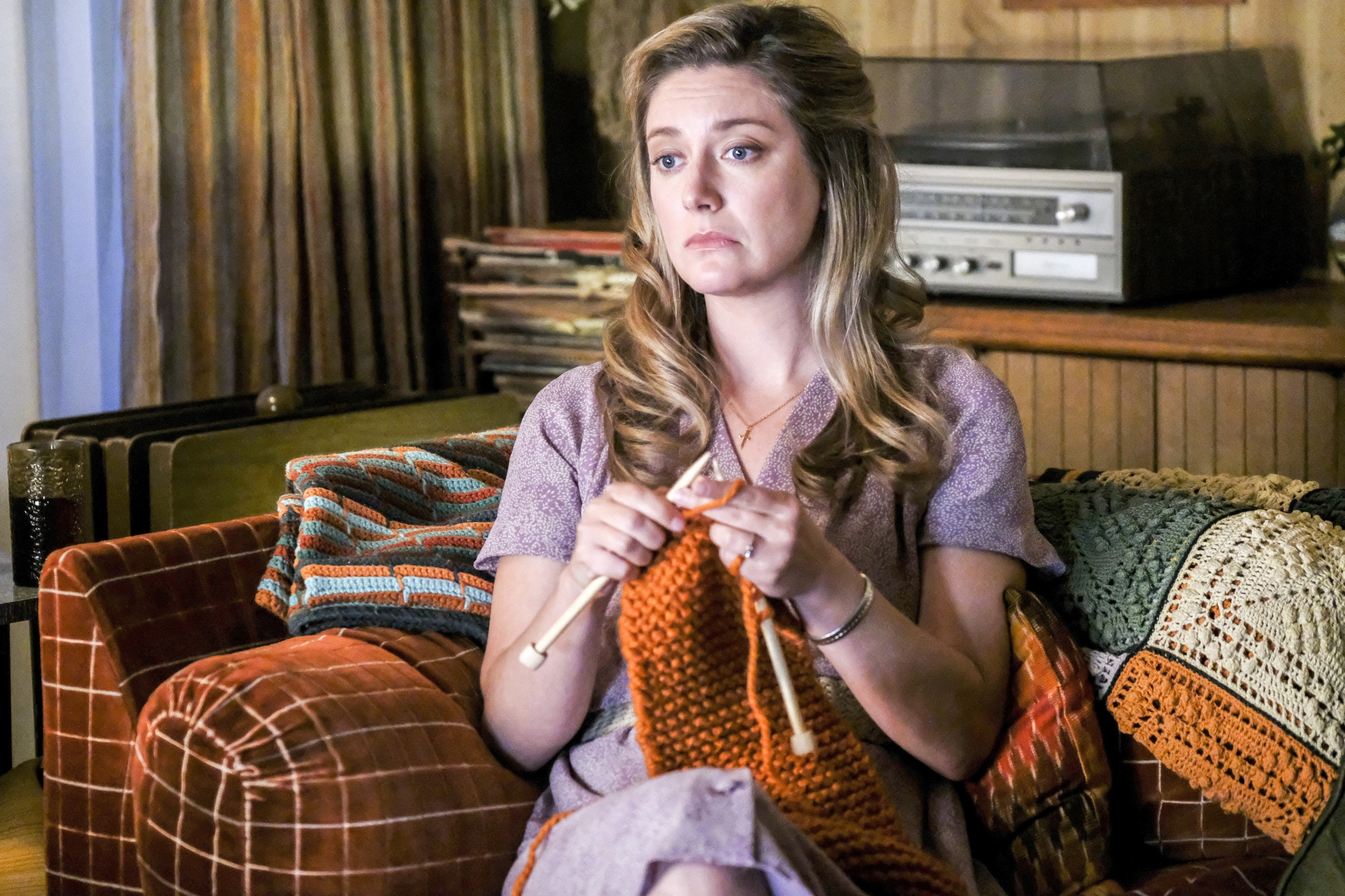 Mary Cooper knitting with a pensive expression HD Wallpaper