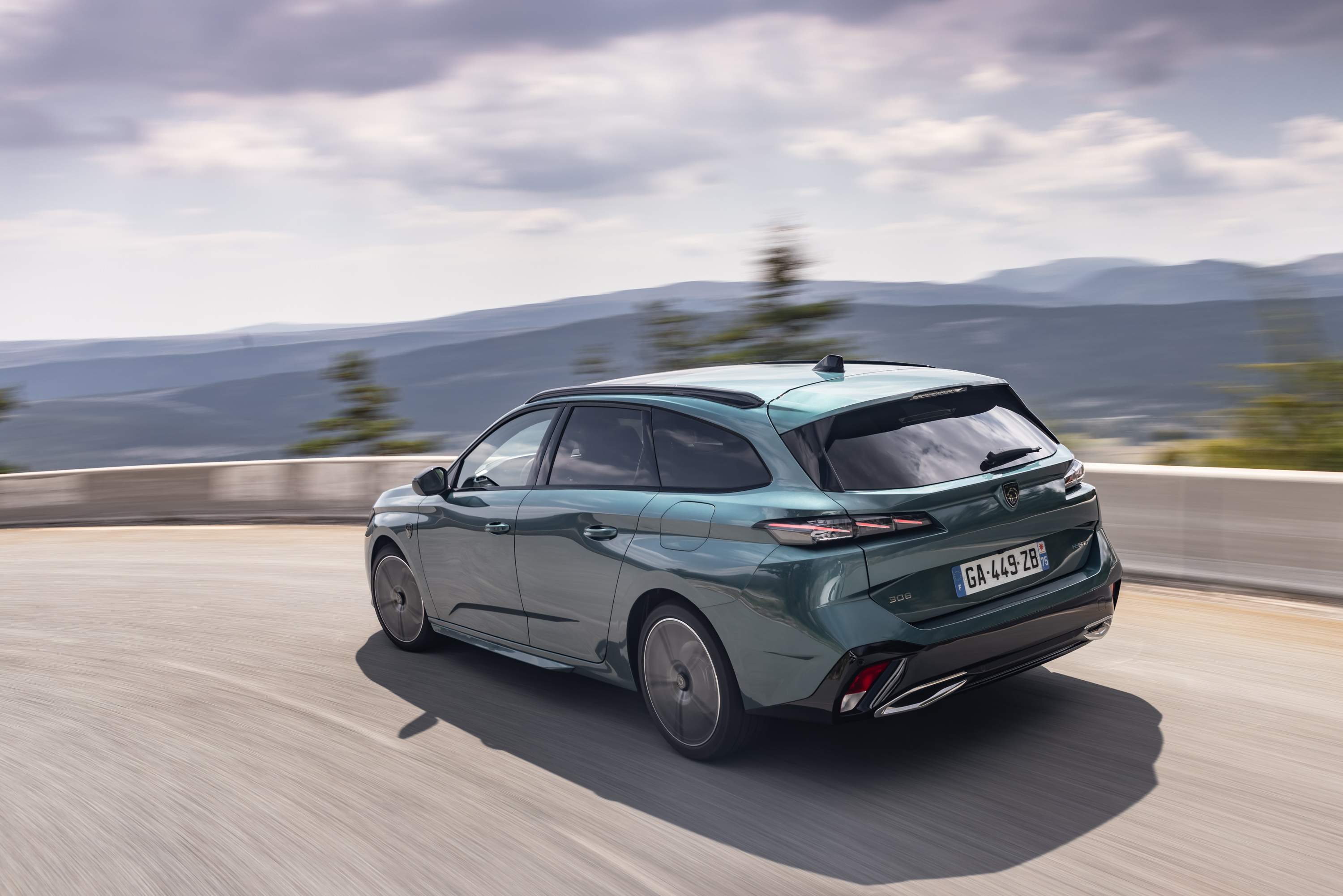 Peugeot 308 SW driving through mountains HD Wallpaper