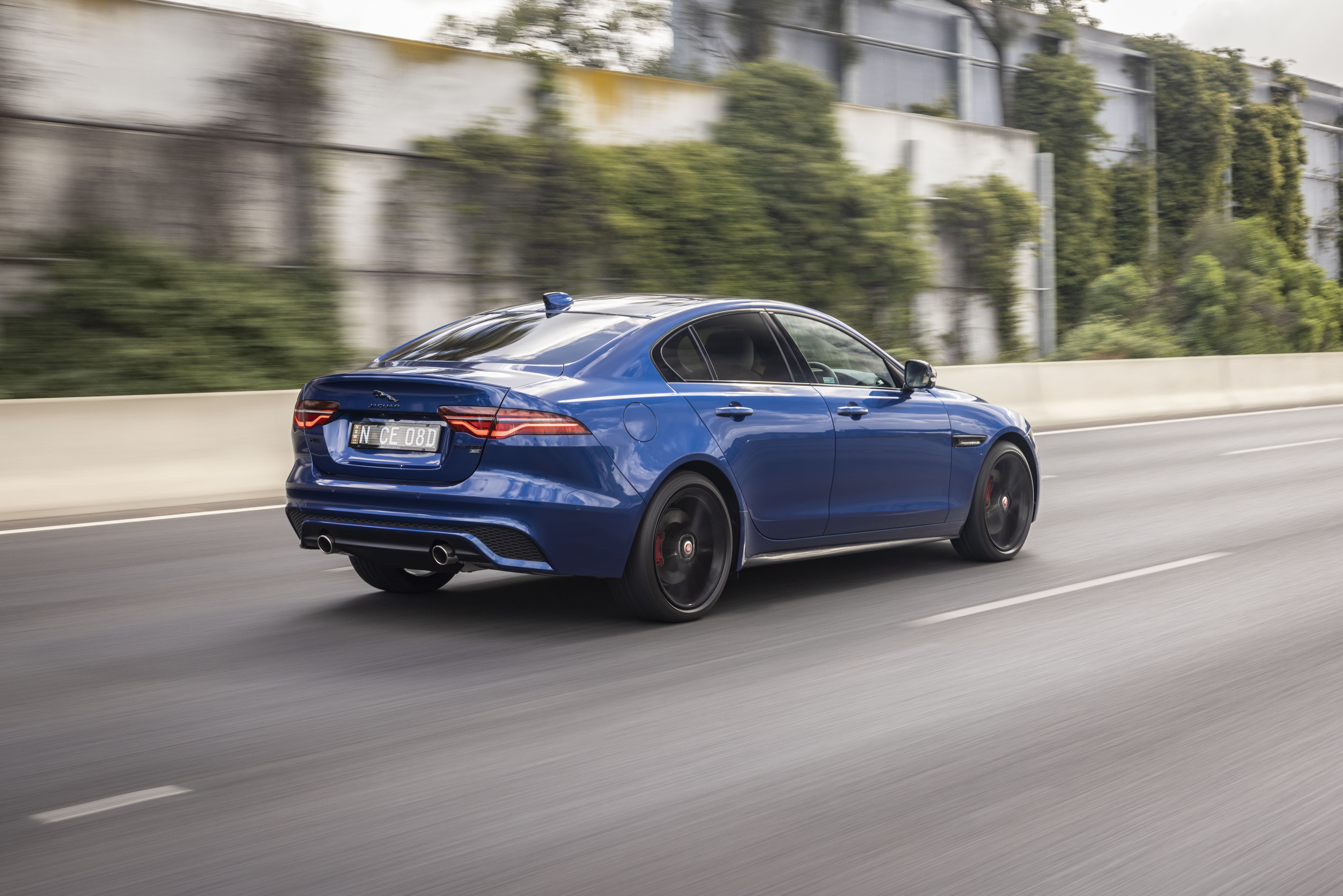 Blue Jaguar XE P300 AWD luxury car on road HD Wallpaper