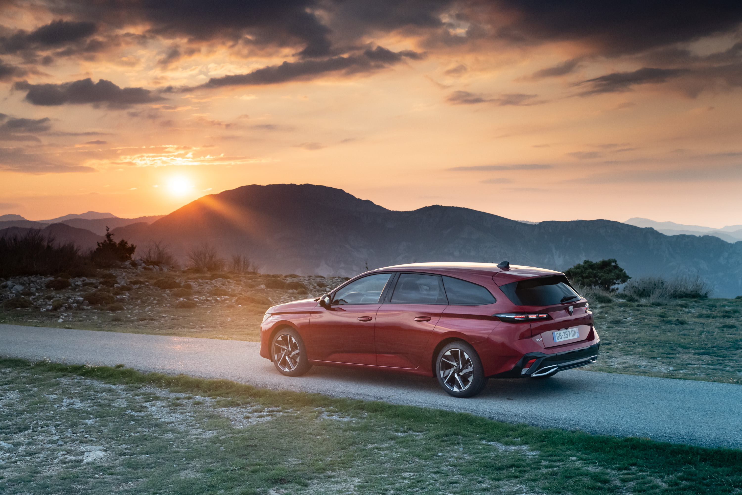 Peugeot 308 SW GT on mountain road at sunset HD Wallpaper