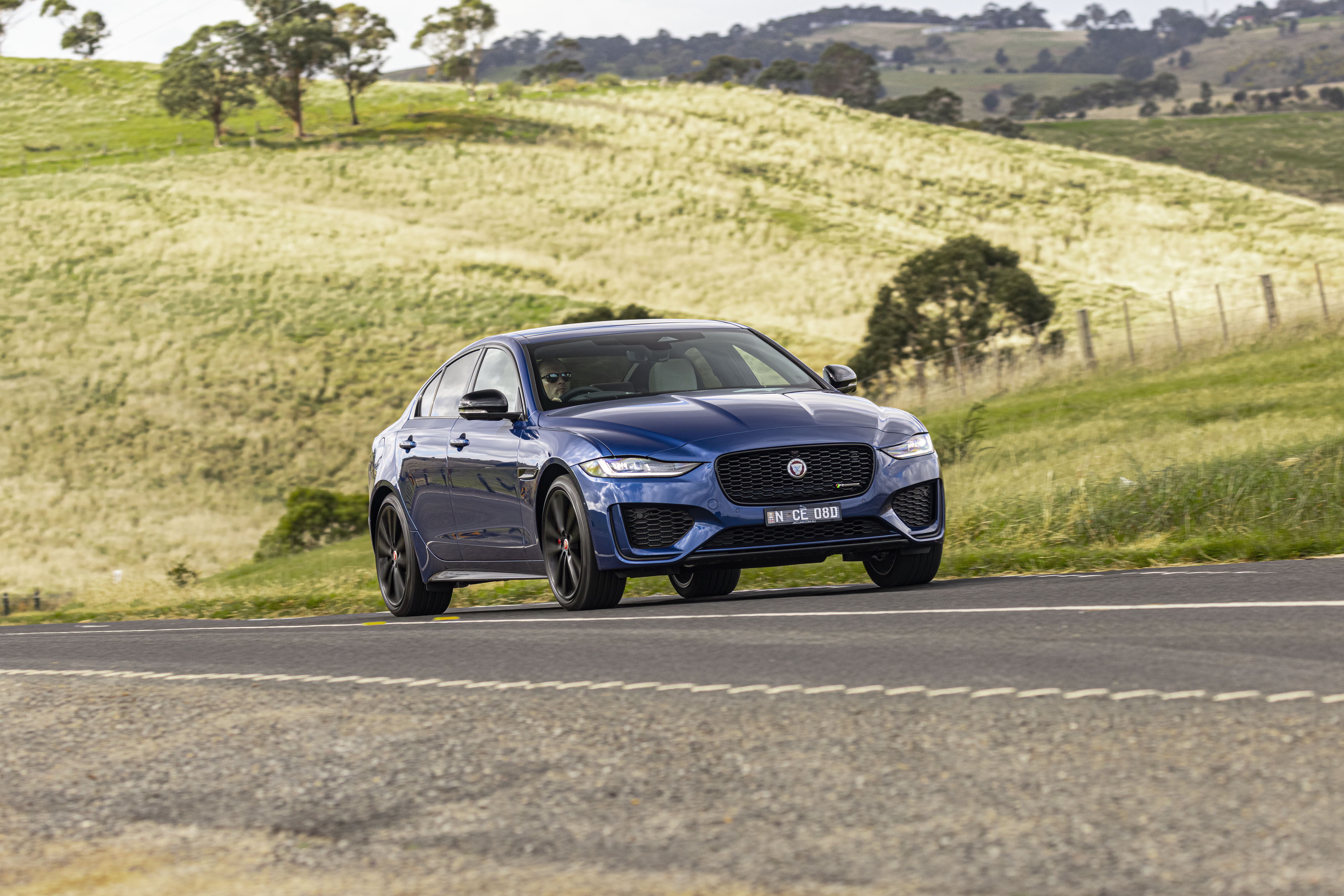 Blue Jaguar XE P300 AWD Luxury Car on a Scenic Road HD Wallpaper