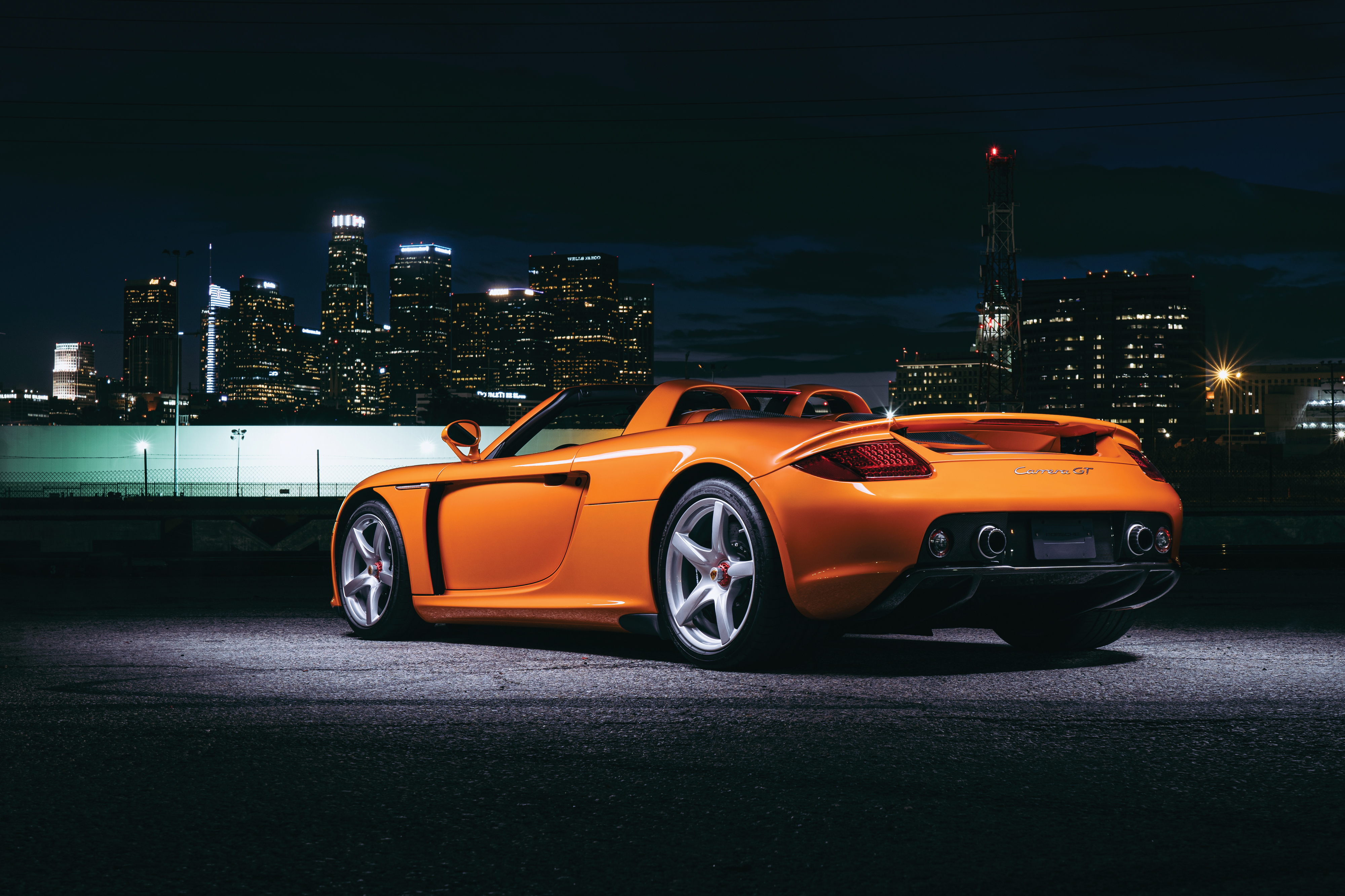 Orange Porsche Carrera GT at night city skyline 4K HD Wallpaper