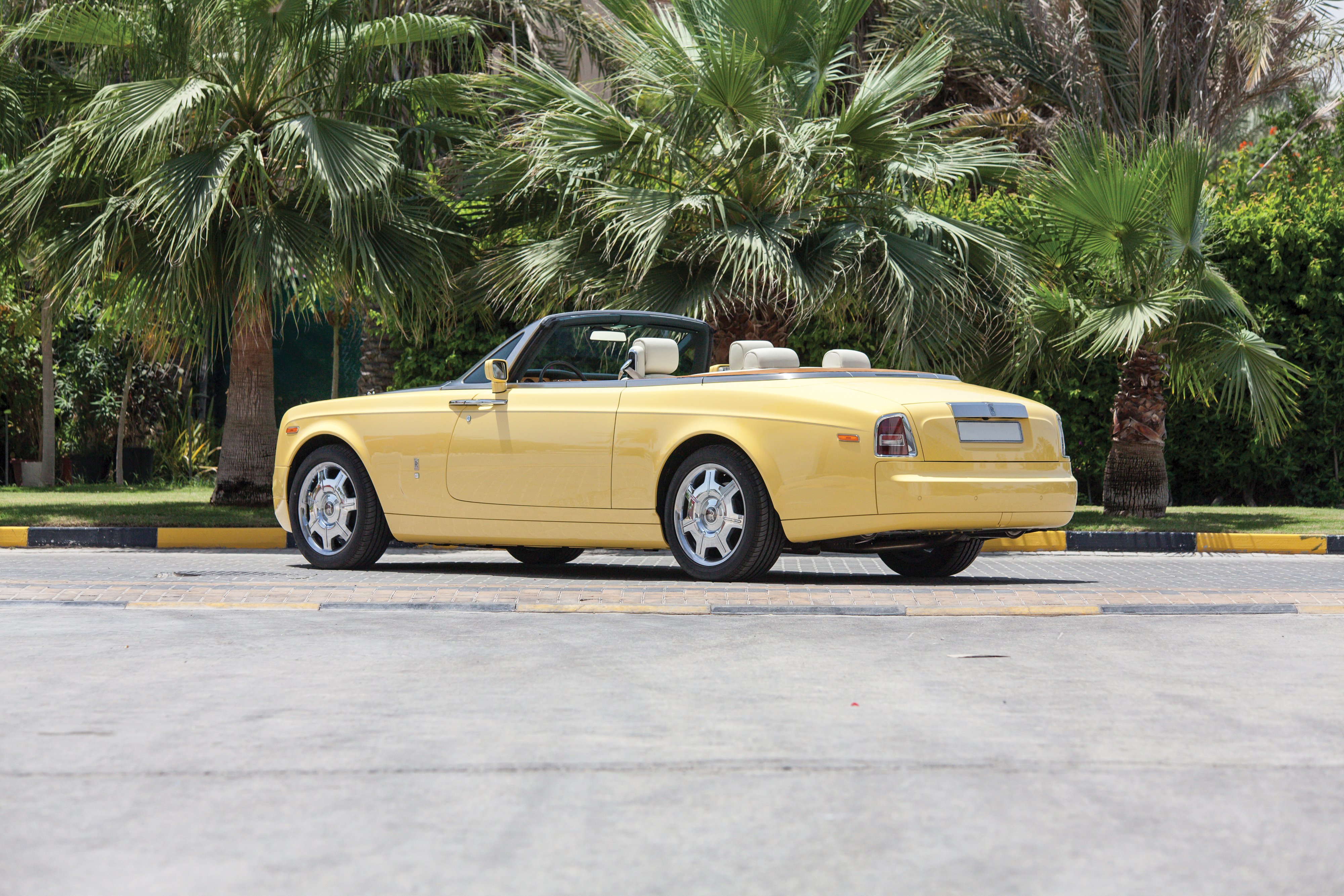 Yellow Rolls-Royce Phantom Cabriolet under palm trees HD Wallpaper