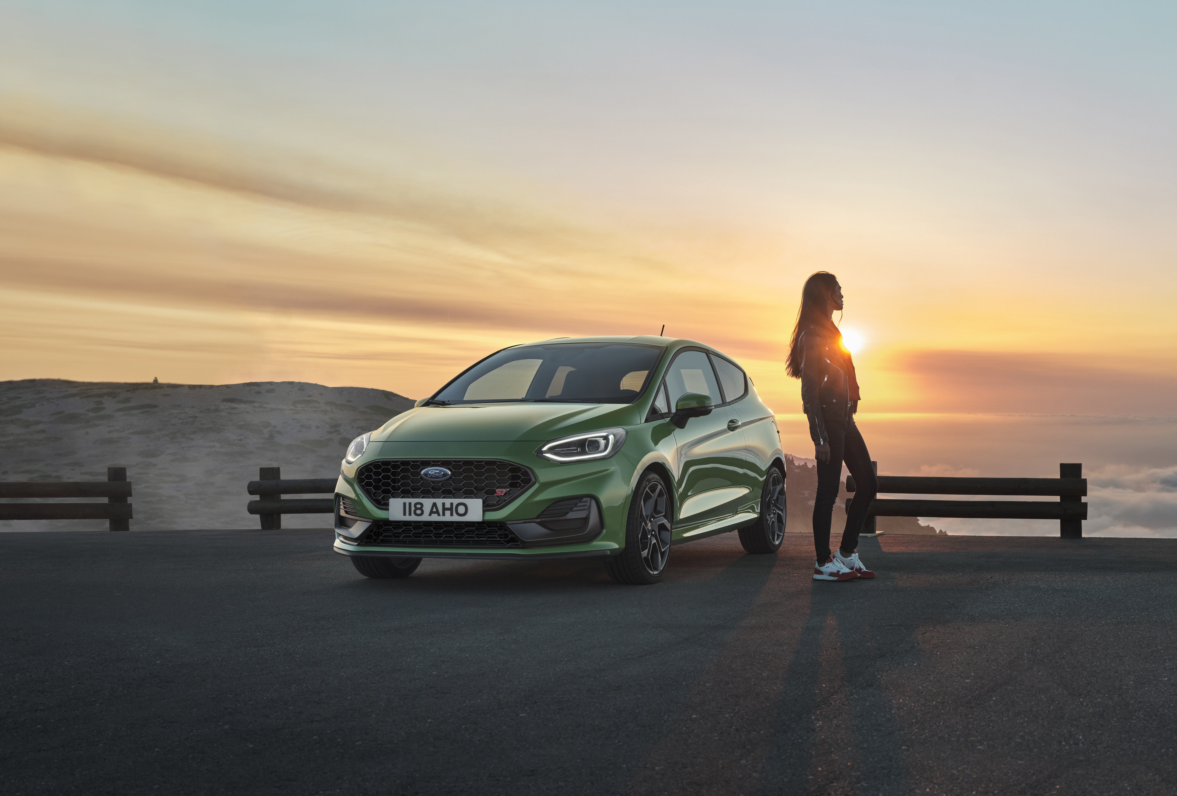 Green Ford Fiesta ST and woman at sunset HD Wallpaper