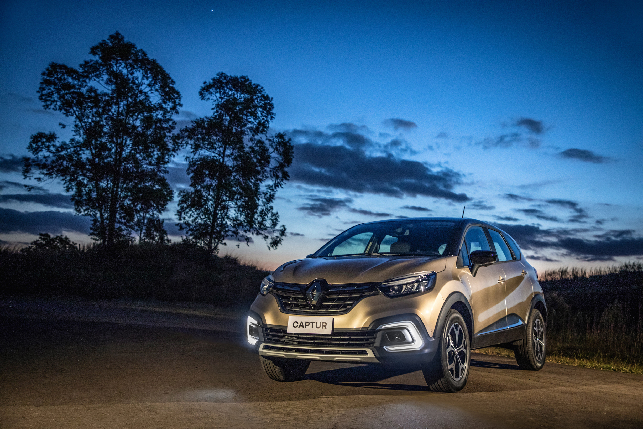 Gold Renault Captur SUV at dusk HD Wallpaper