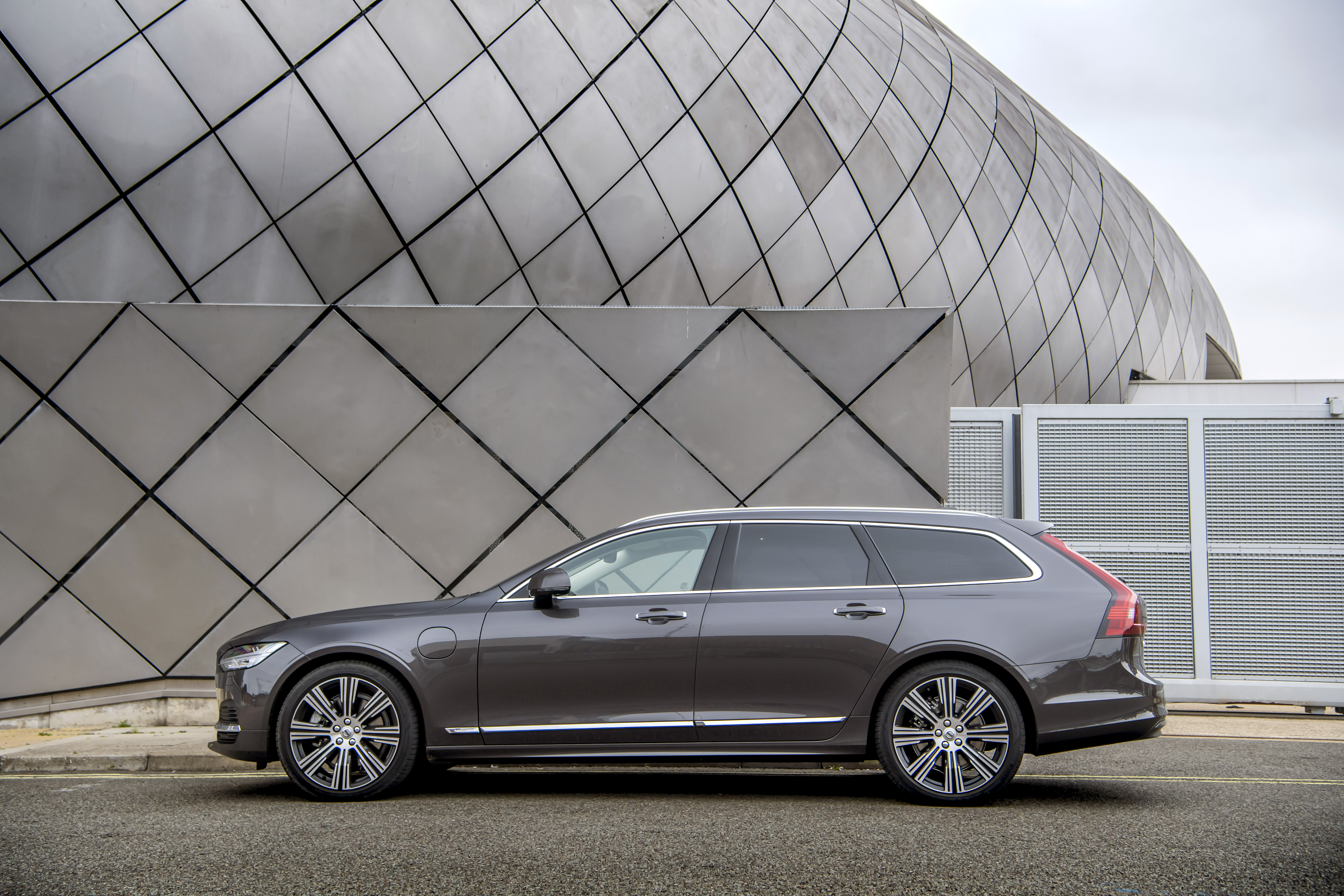 Luxury Volvo V90 station wagon against geometric building HD Wallpaper
