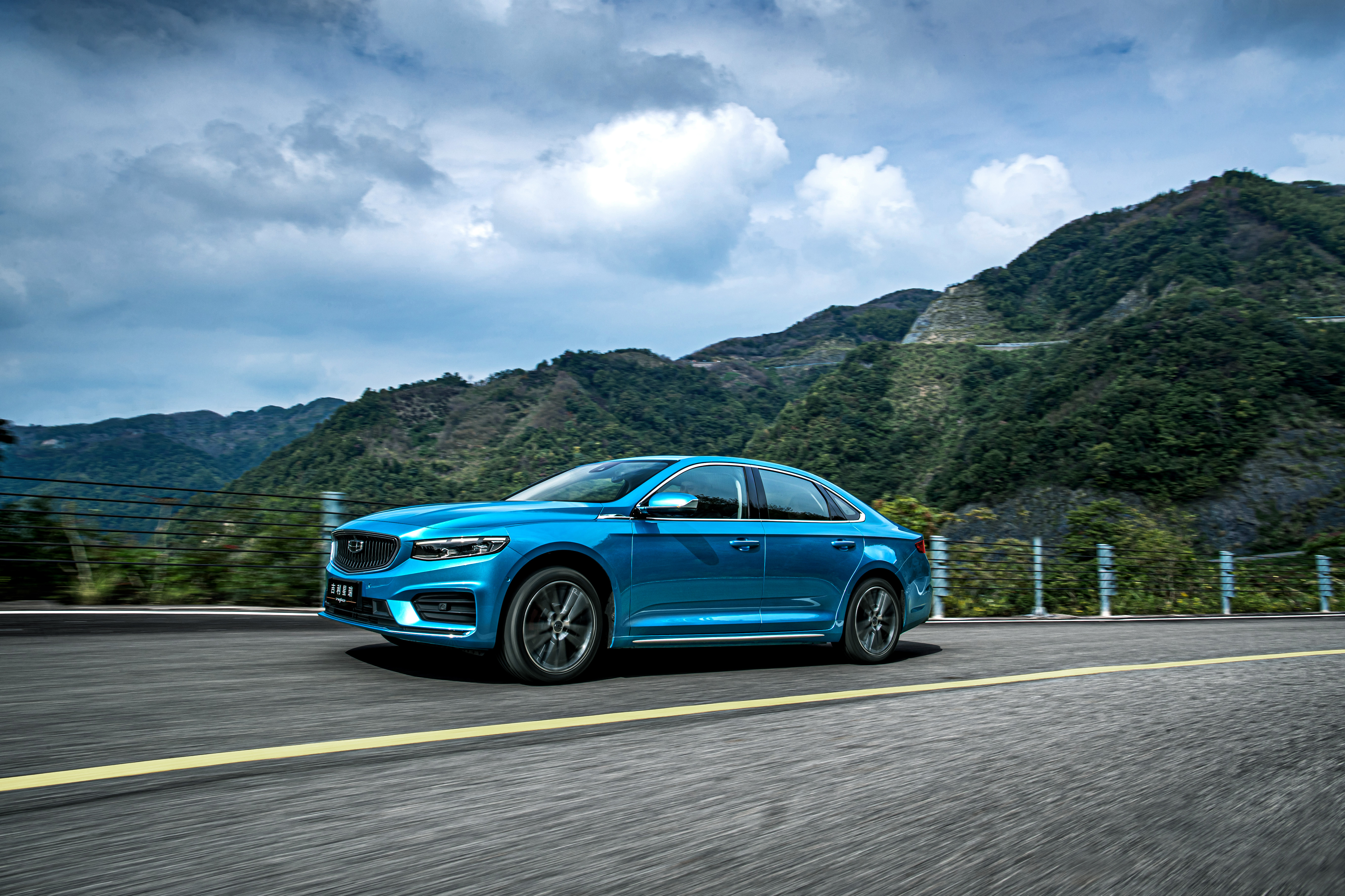 Blue Geely Preface Sedan Driving on Mountain Road 4K HD Wallpaper
