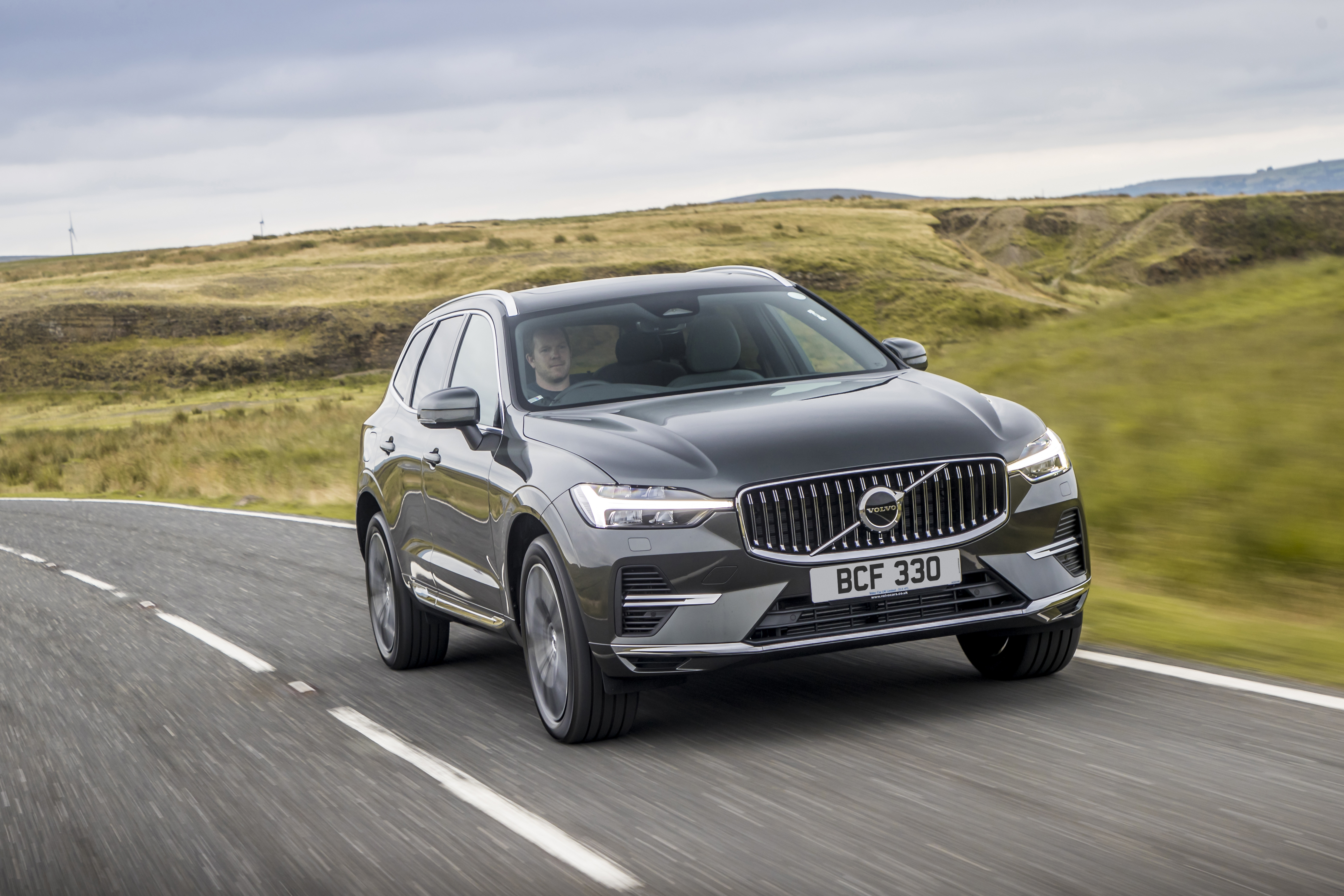 Volvo XC60 SUV driving on a winding country road HD Wallpaper