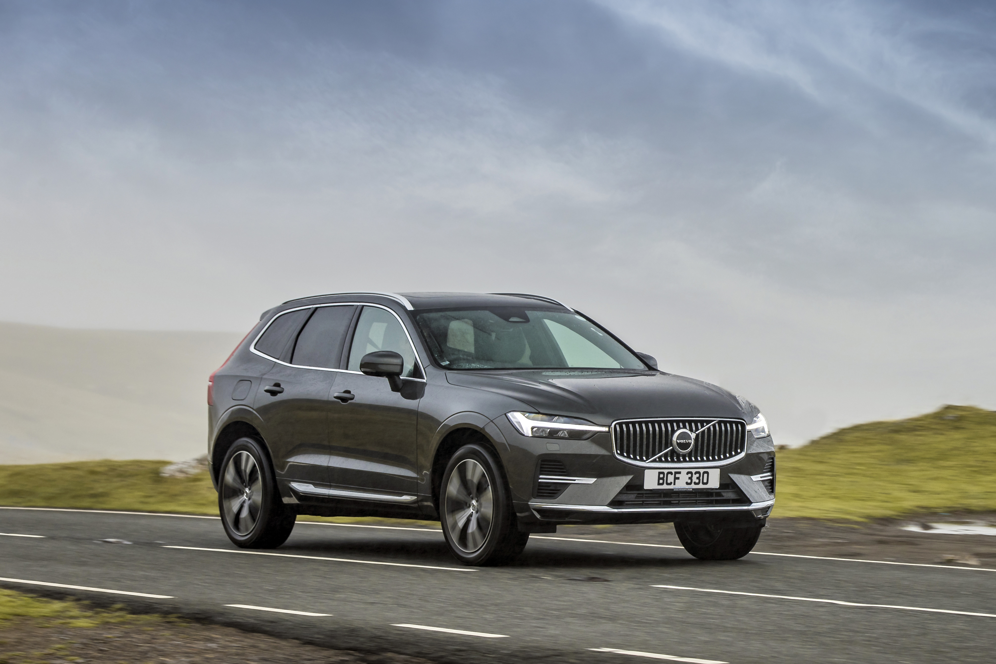 Volvo XC60 T6 Recharge AWD SUV driving on a road HD Wallpaper