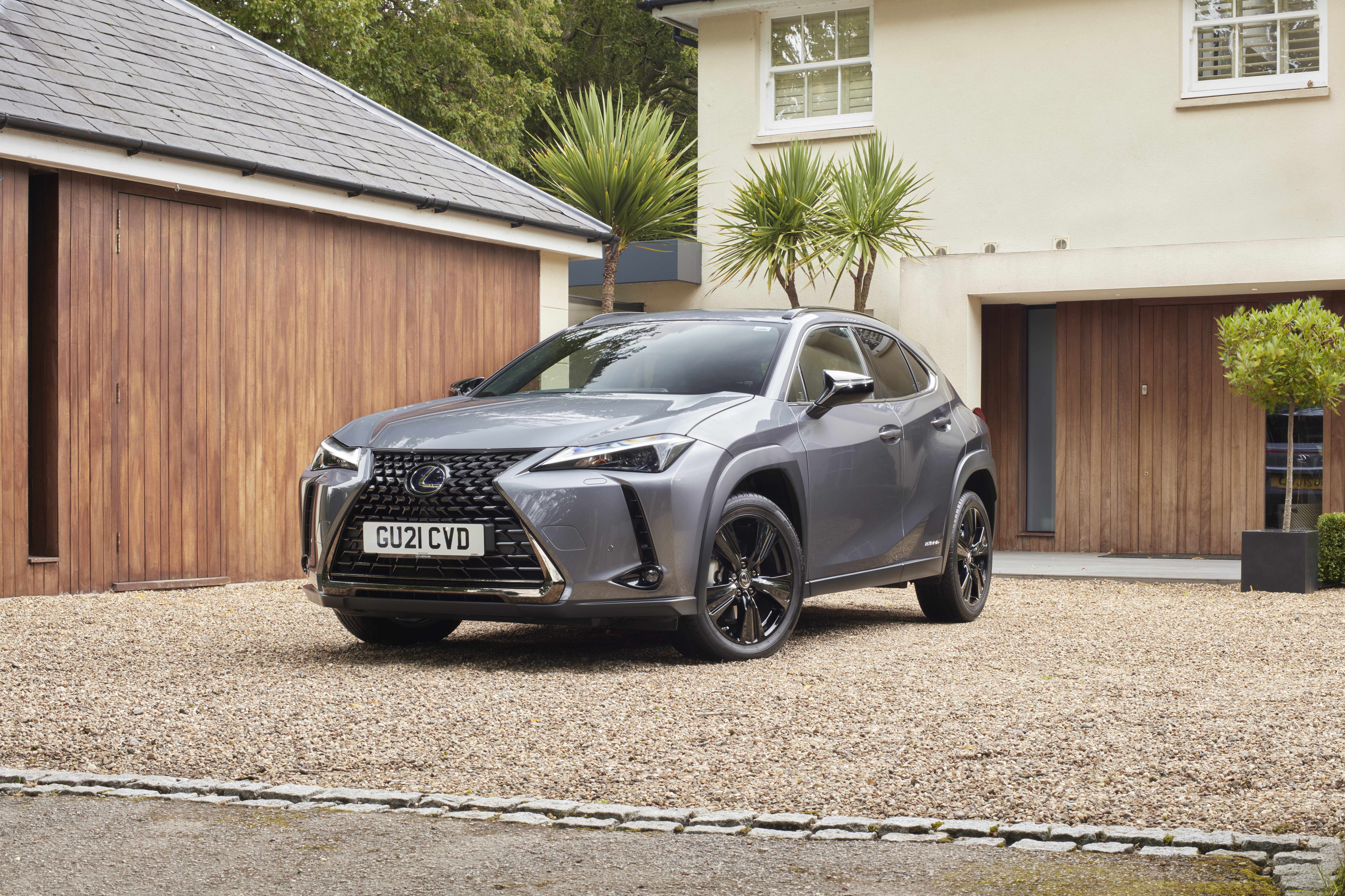 Lexus UX 250H luxury SUV on gravel driveway HD Wallpaper