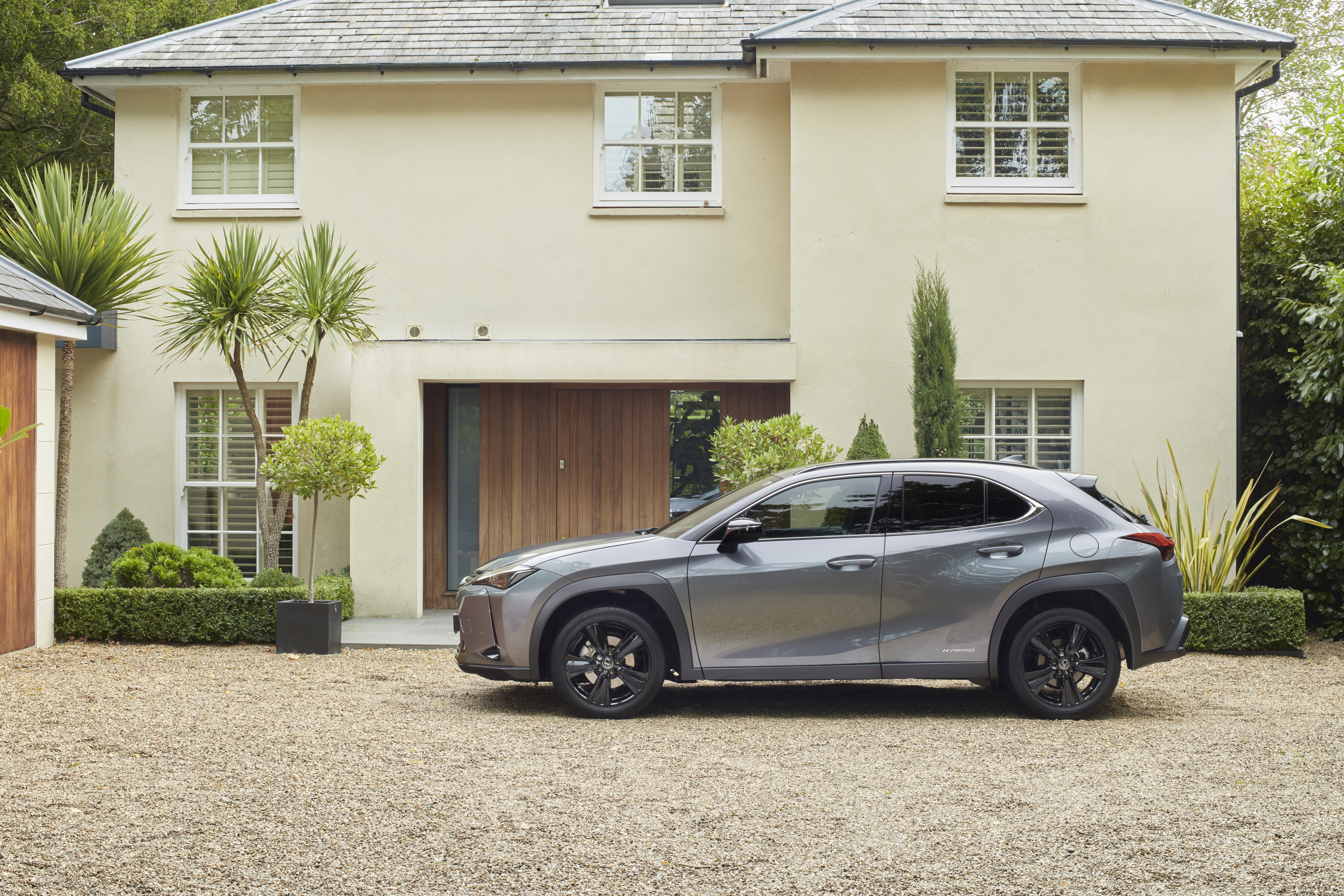 Lexus UX 250H luxury SUV parked outside a home HD Wallpaper