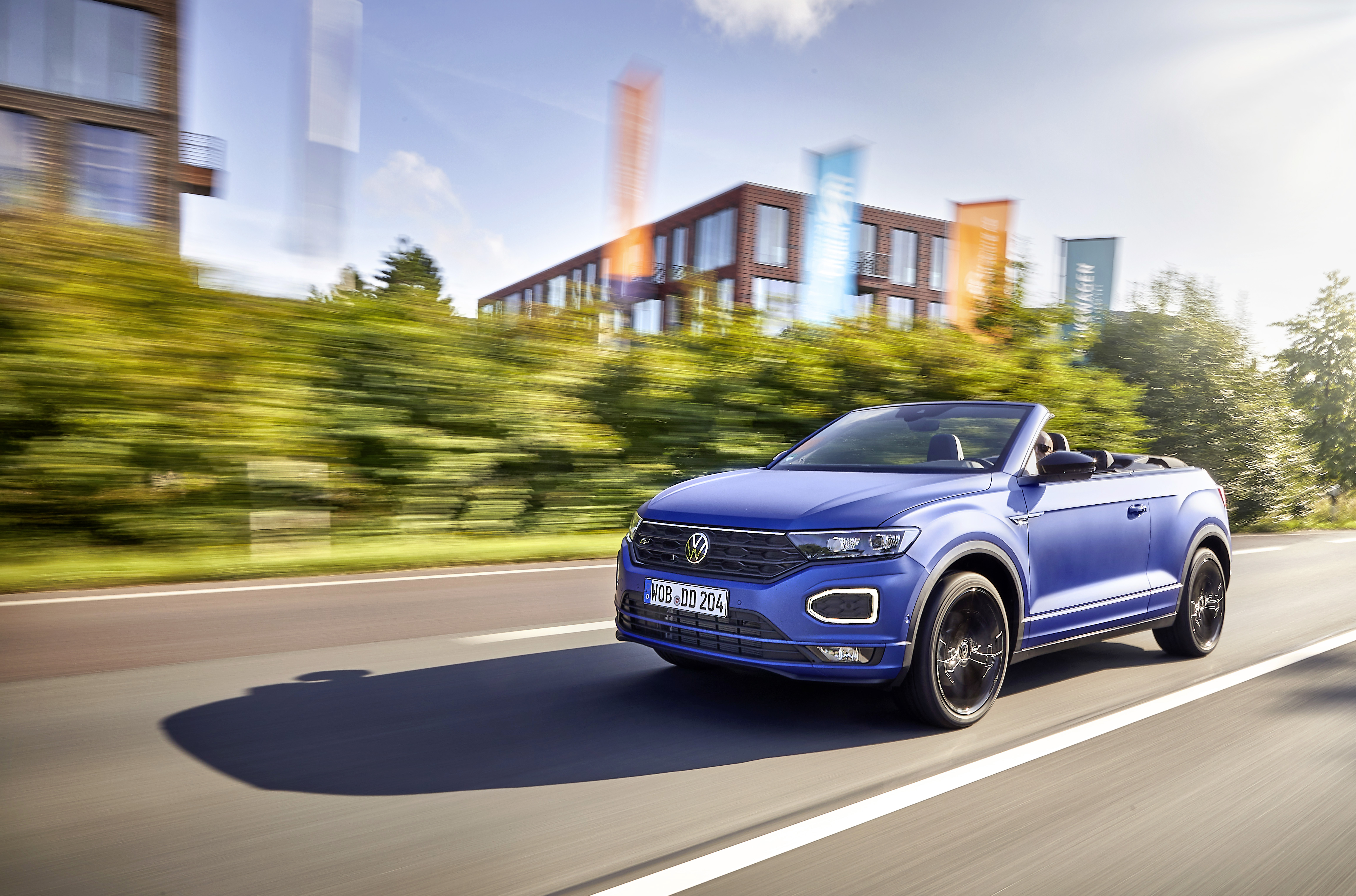 Volkswagen T-Roc Cabriolet R-Line "Edition Blue" driving on road HD Wallpaper