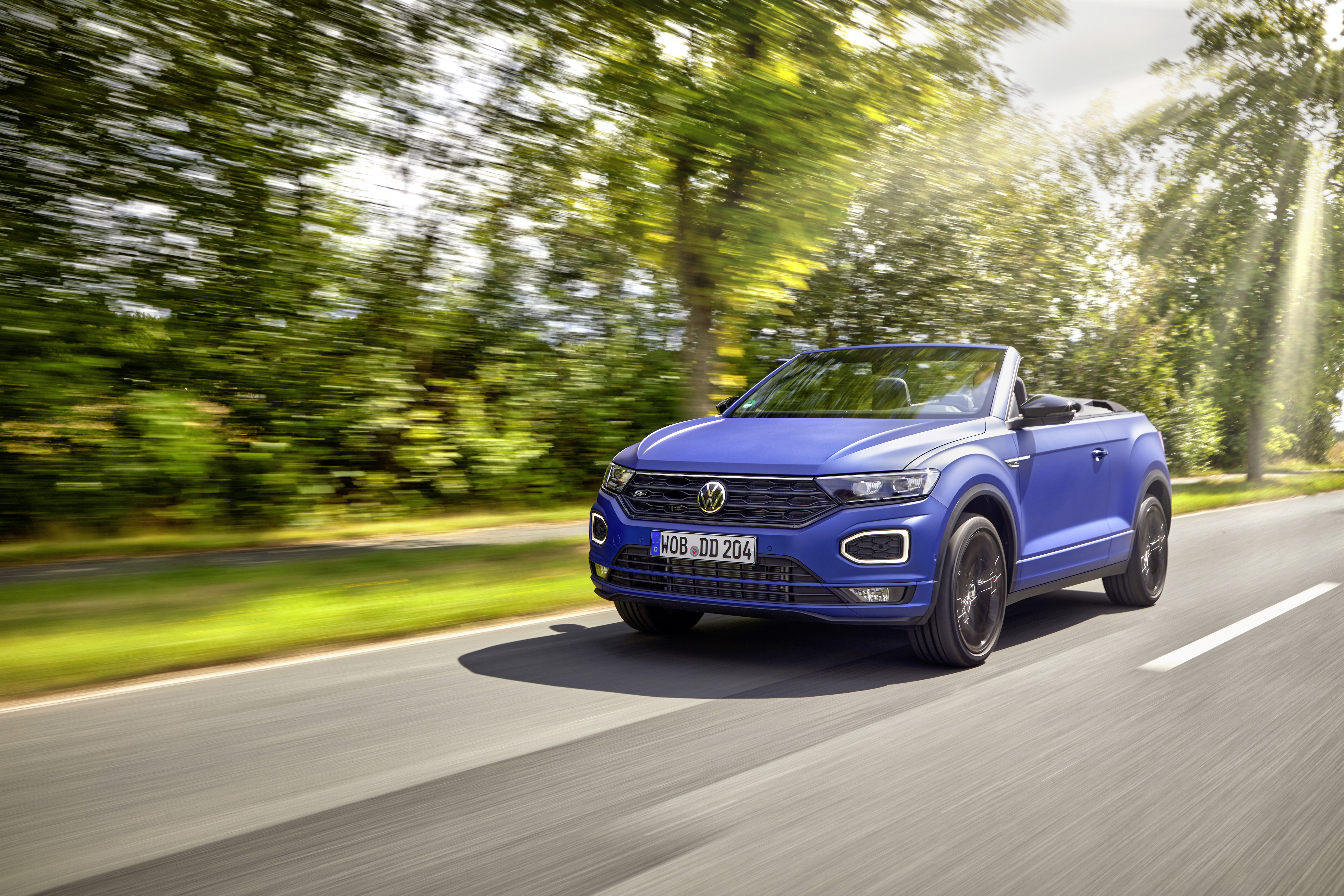 Blue Volkswagen T-Roc Cabriolet R-Line driving on a sunny road HD Wallpaper