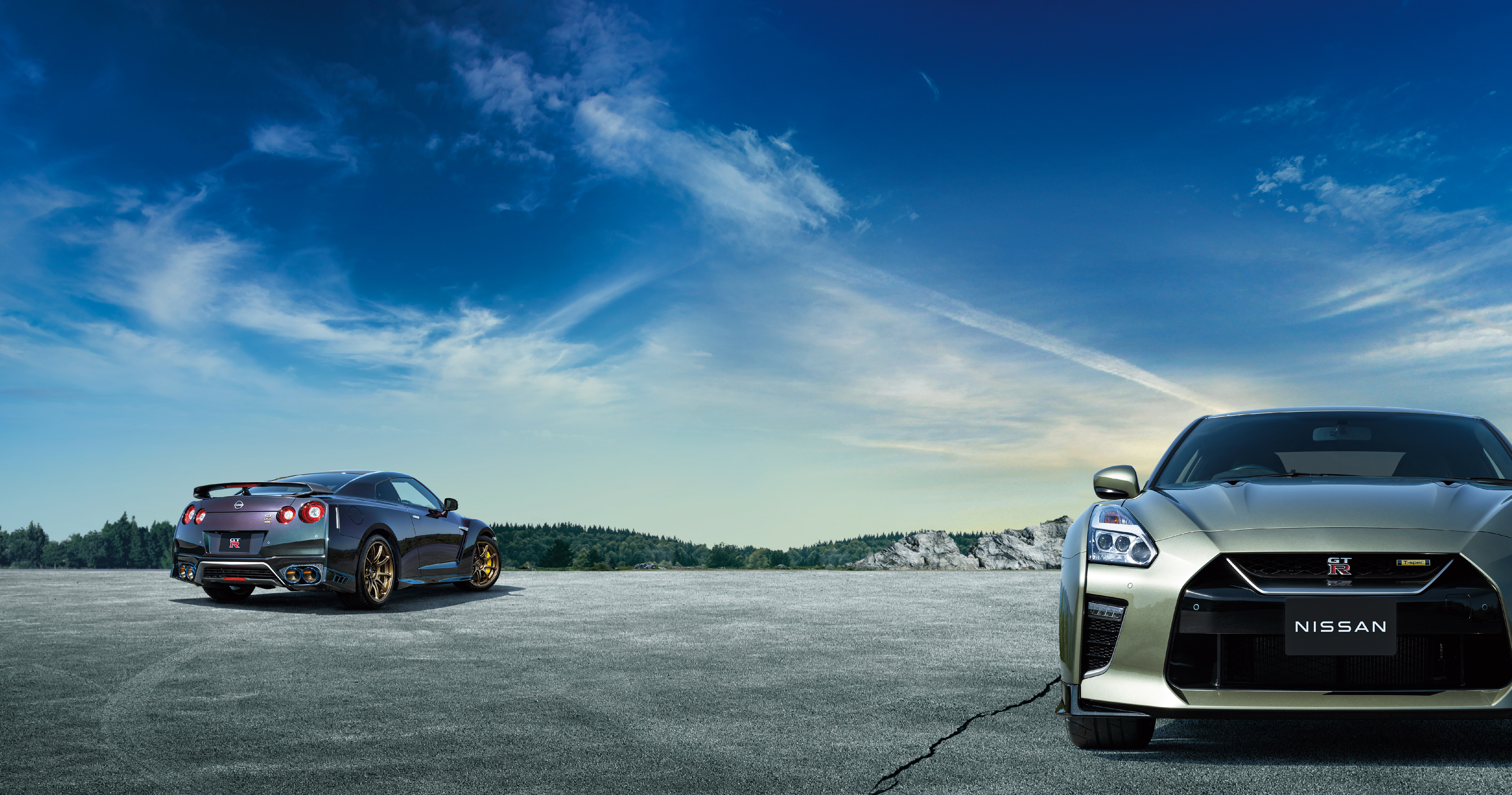Two Nissan GT-R R35 sport cars on tarmac. HD Wallpaper