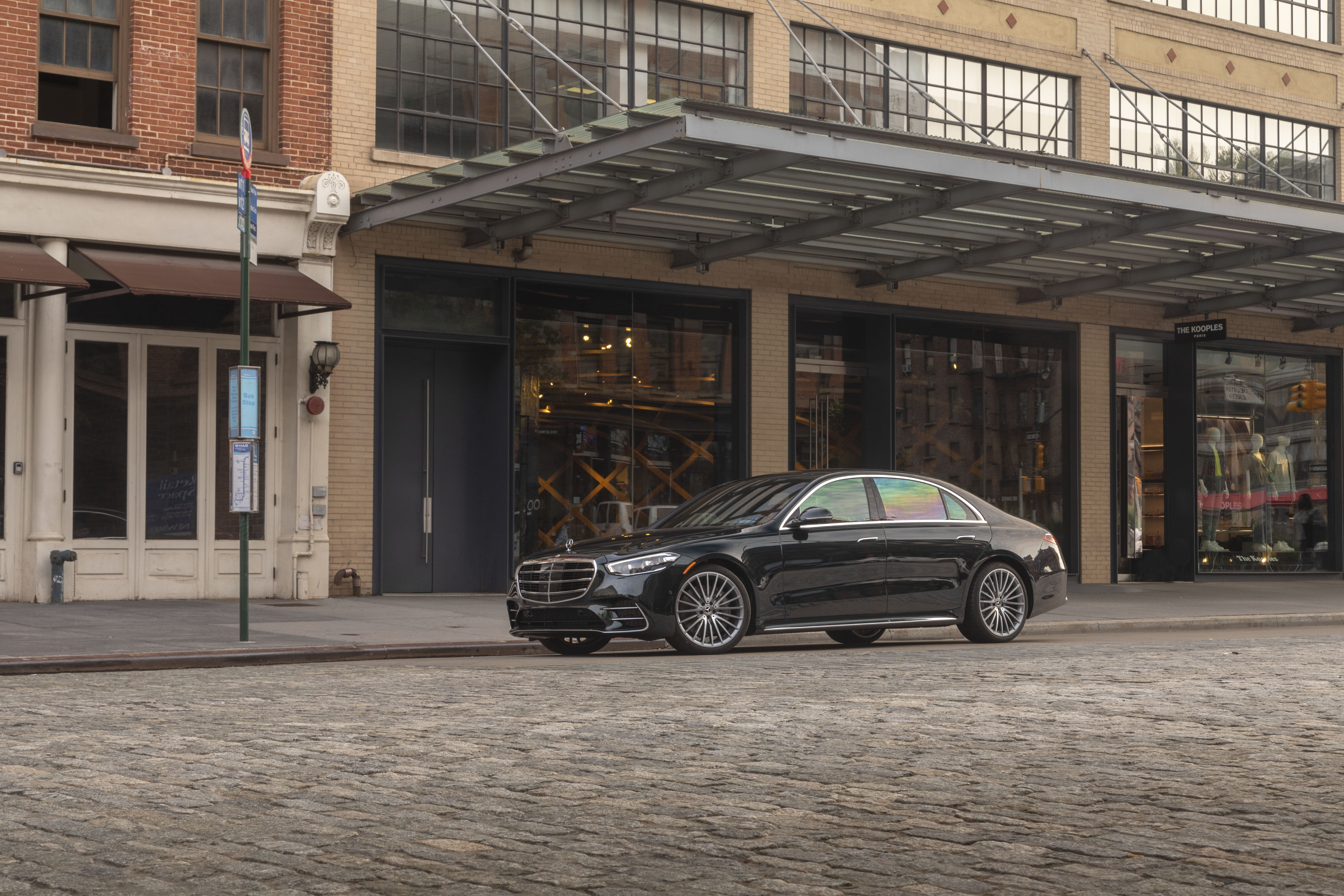 Black Mercedes-Benz S 500 luxury car on cobblestone street HD Wallpaper
