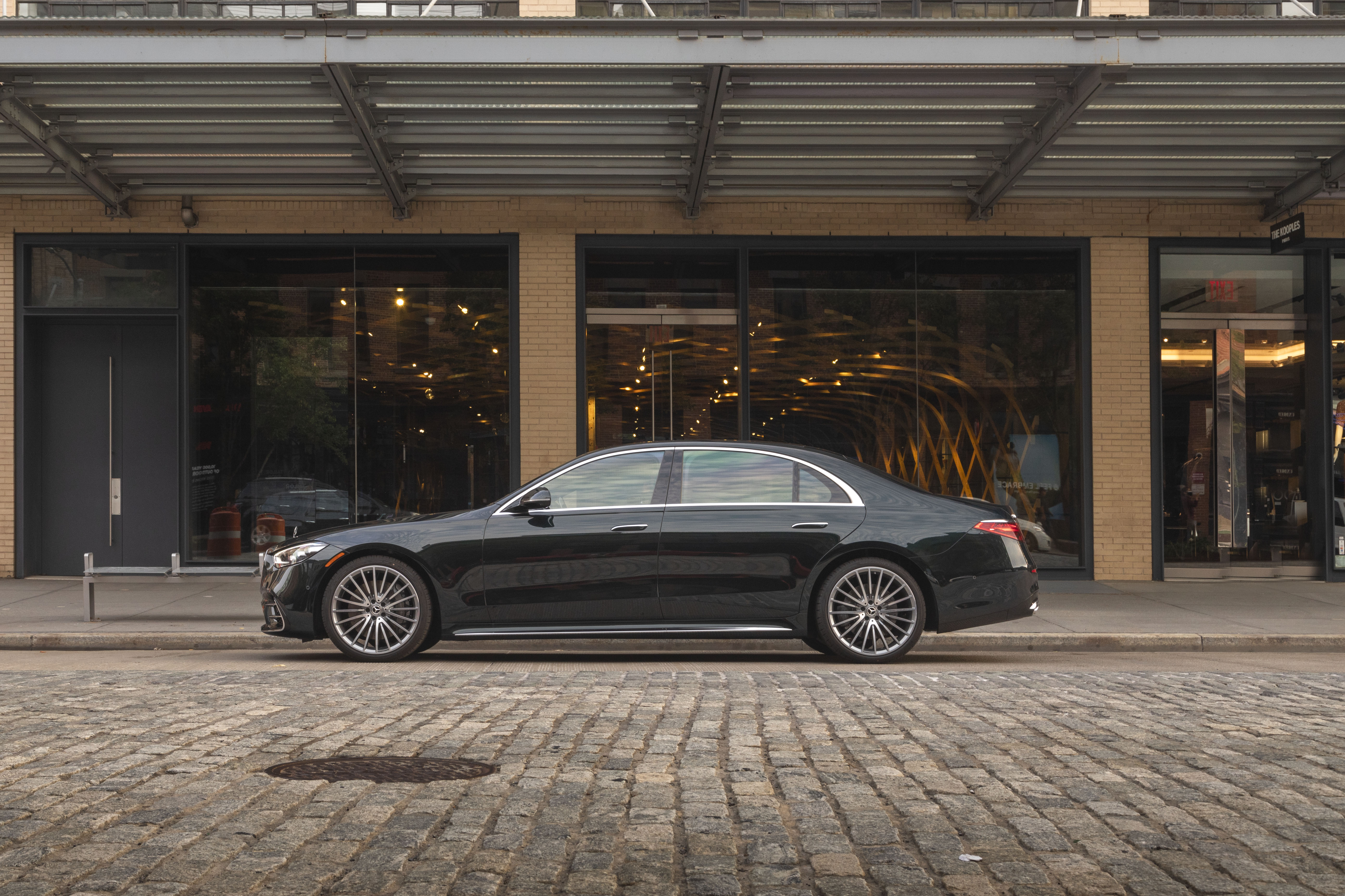 Black Mercedes-Benz S 500 luxury car on cobblestone street HD Wallpaper