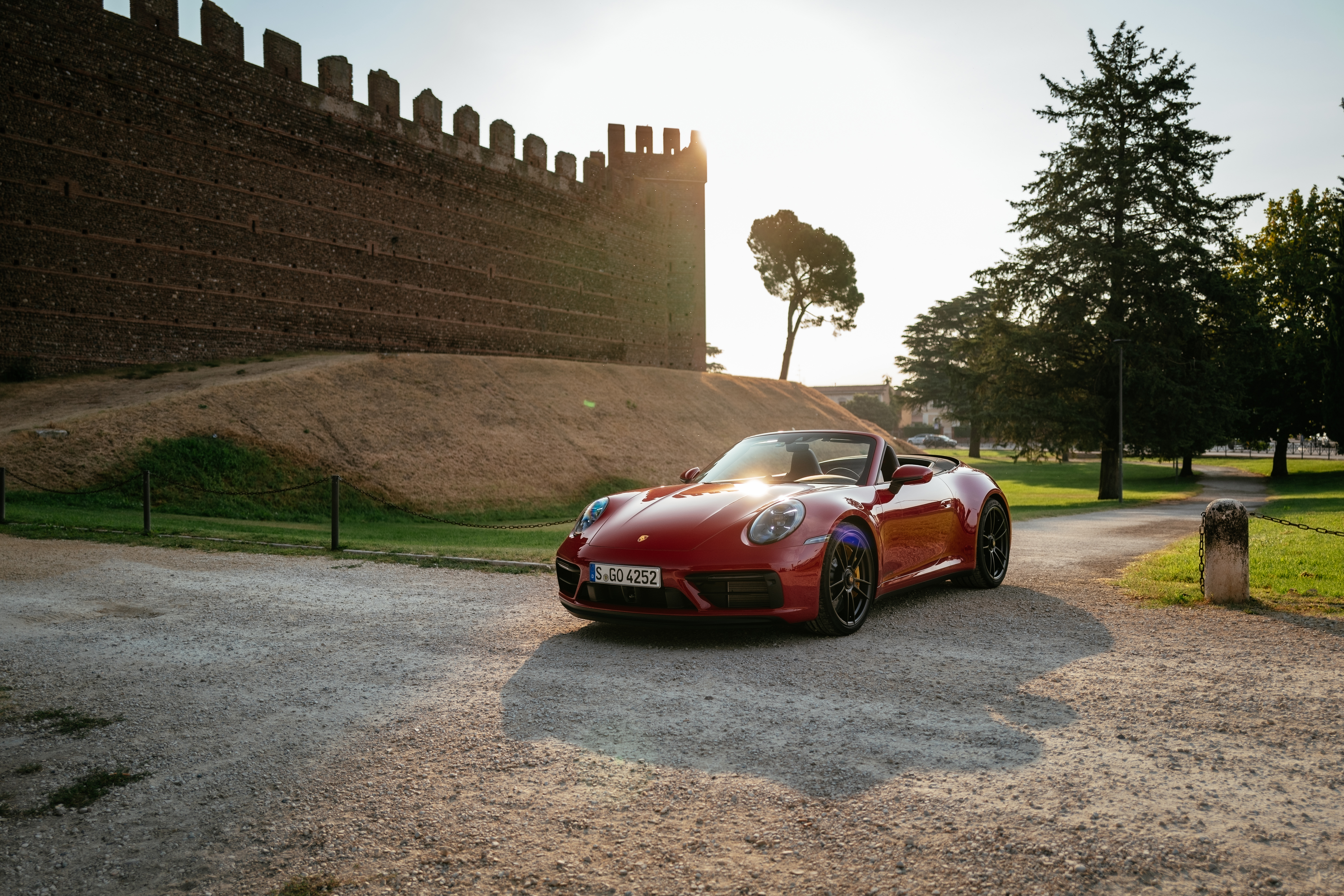 Red Porsche 911 Carrera GTS Cabriolet (992) by ancient wall HD Wallpaper