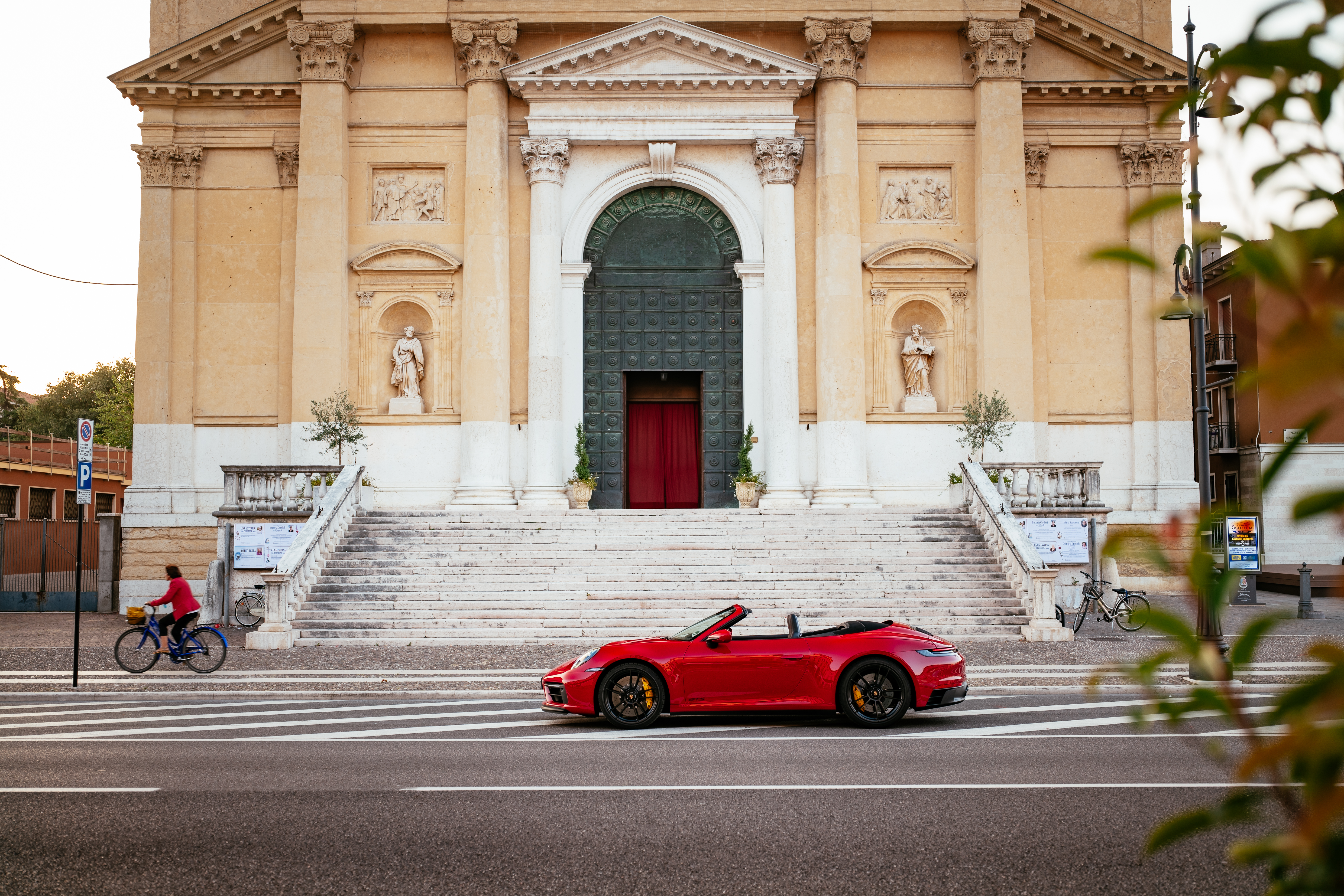 Red Porsche 911 Carrera GTS Cabriolet in front of a church HD Wallpaper