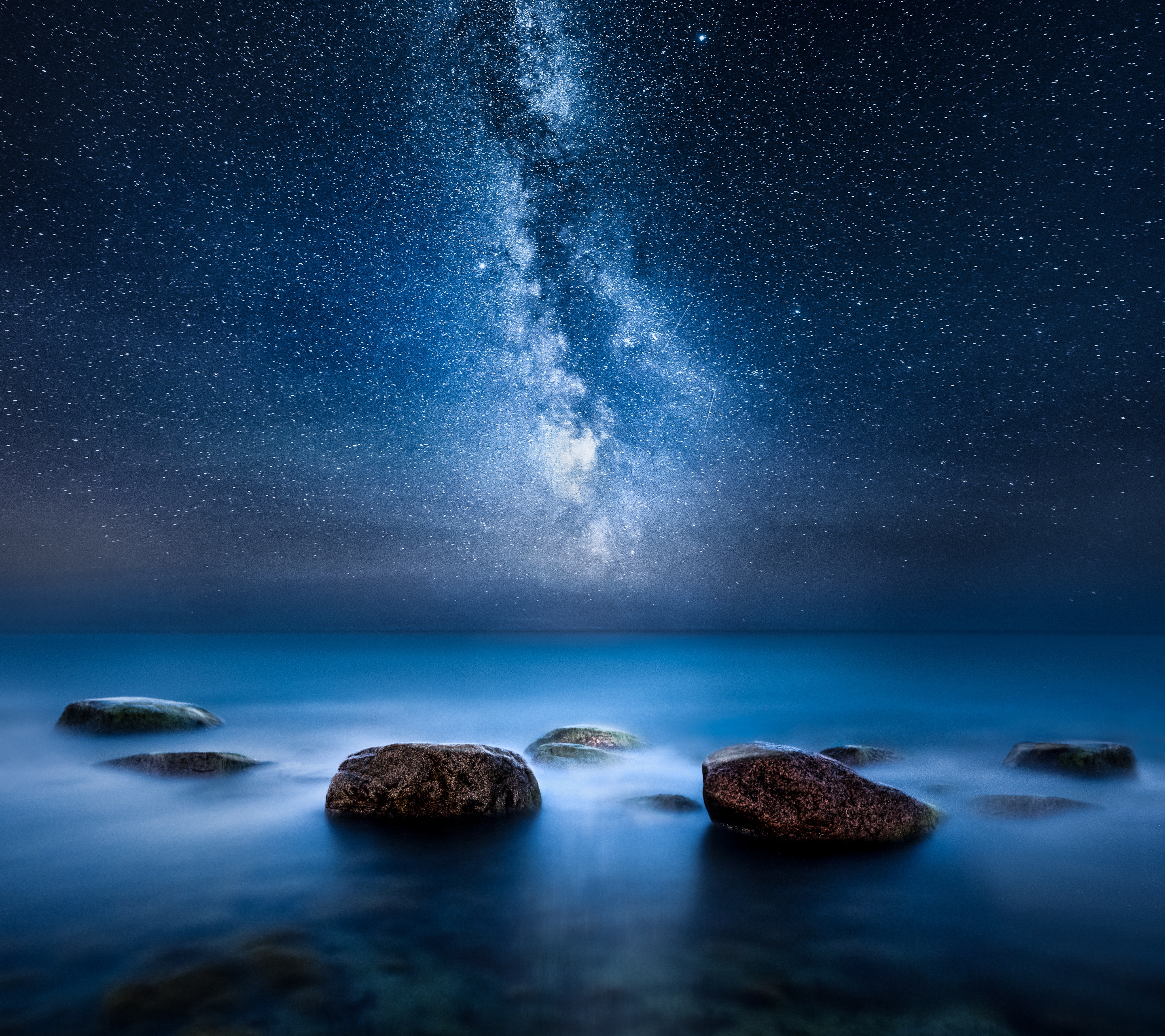 Milky Way and Stars Over Rocks in Serene Water HD Wallpaper