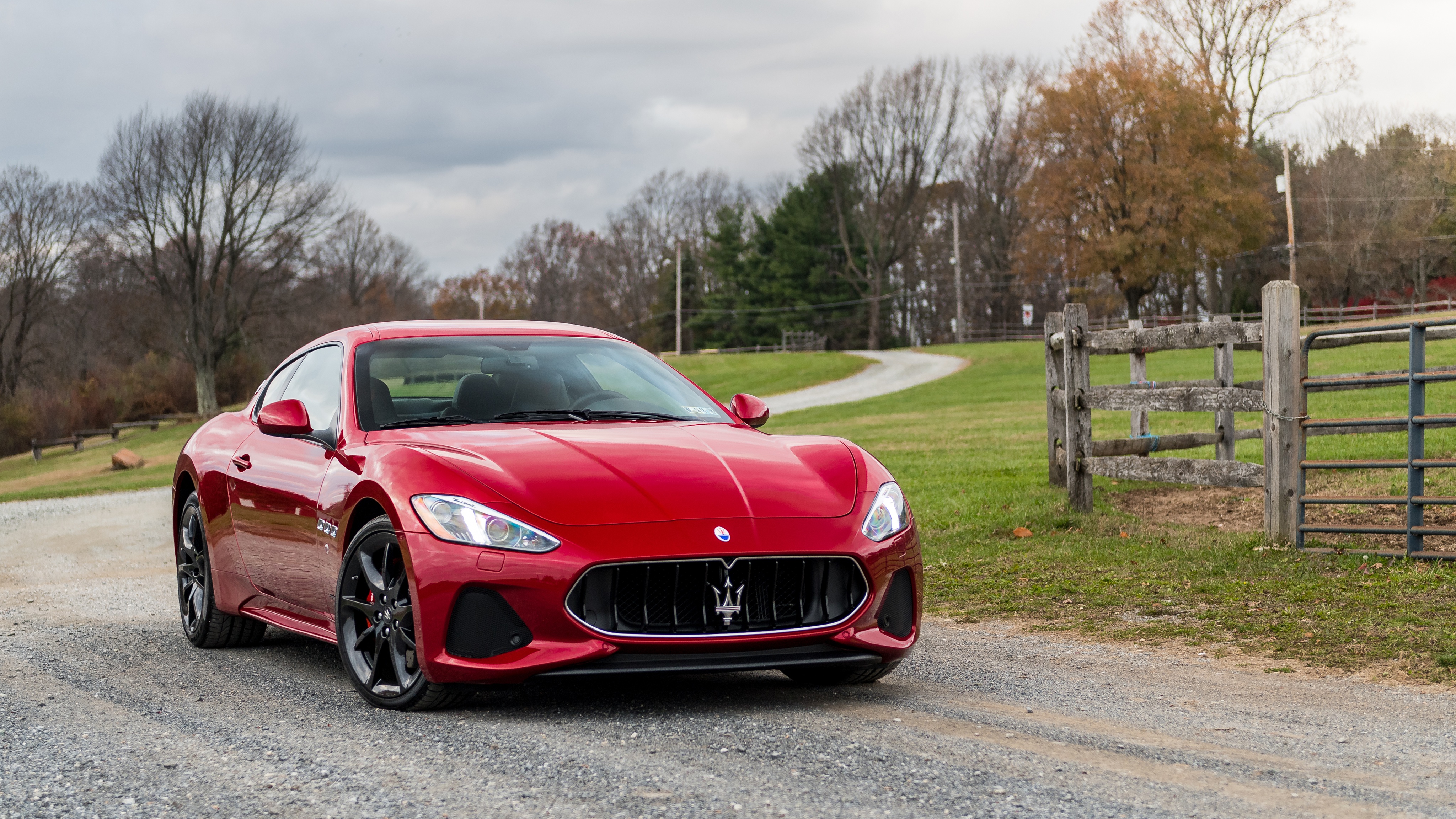 Red Maserati GranTurismo sport car on a gravel road 4K HD Wallpaper