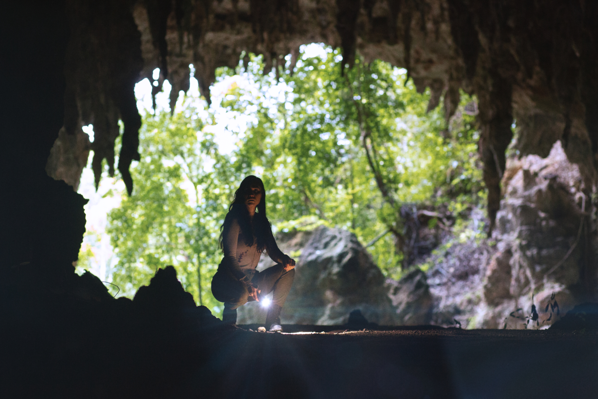 Brigitte Kali Canales exploring a cave in The Old Ways HD Wallpaper