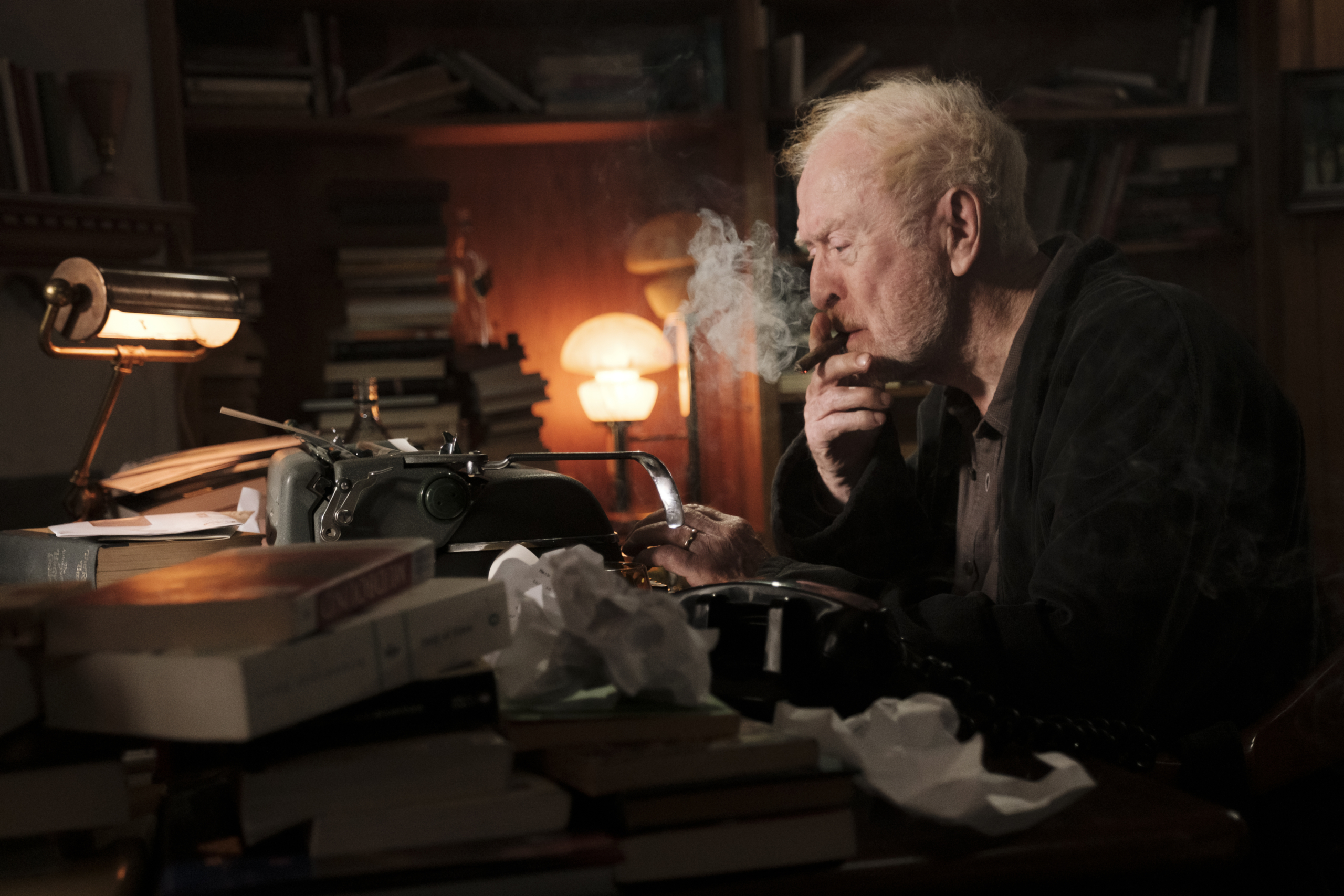 Michael Caine smoking a cigar at his typewriter HD Wallpaper