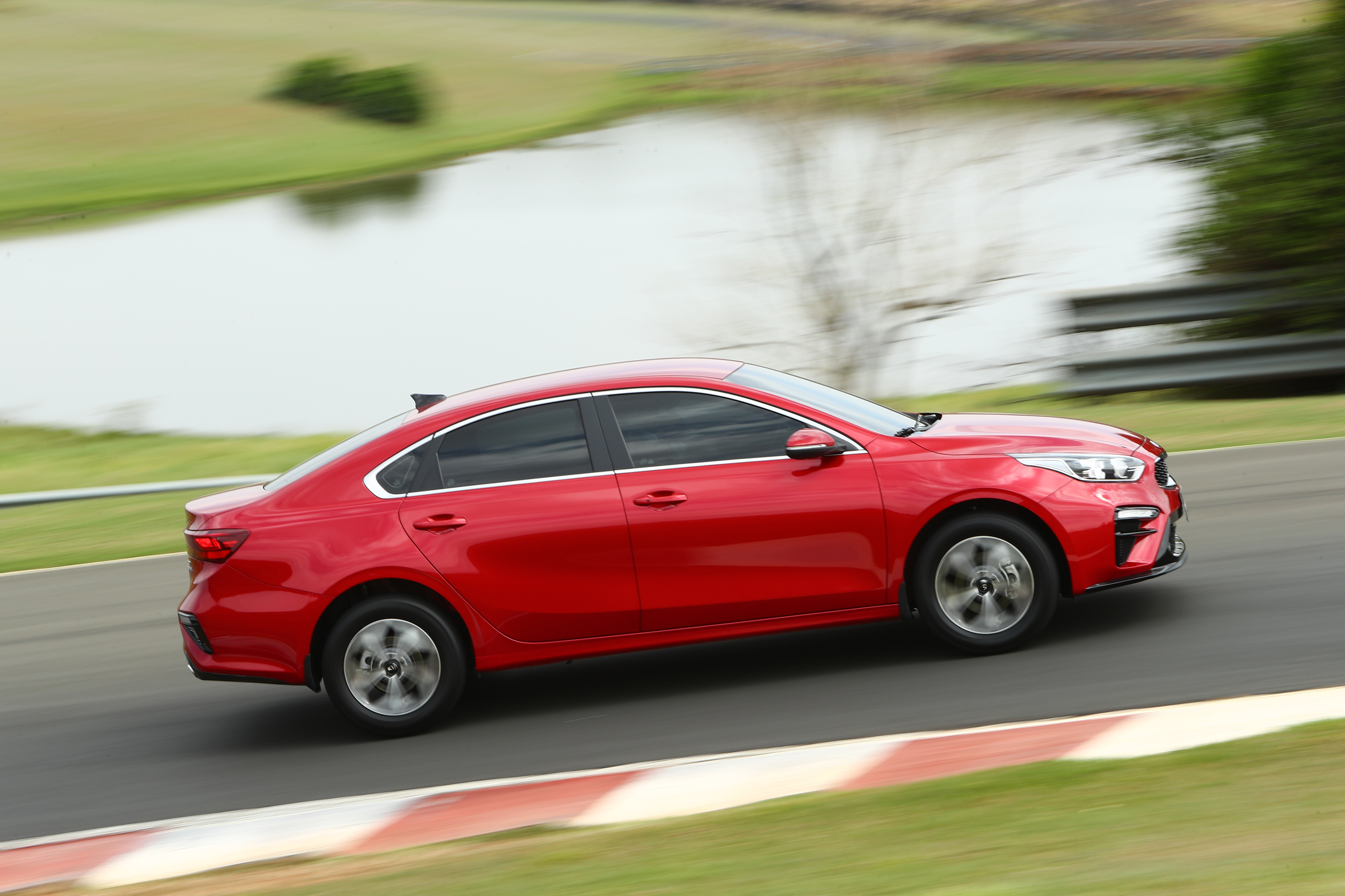 Red Kia Cerato 4K compact car in motion HD Wallpaper
