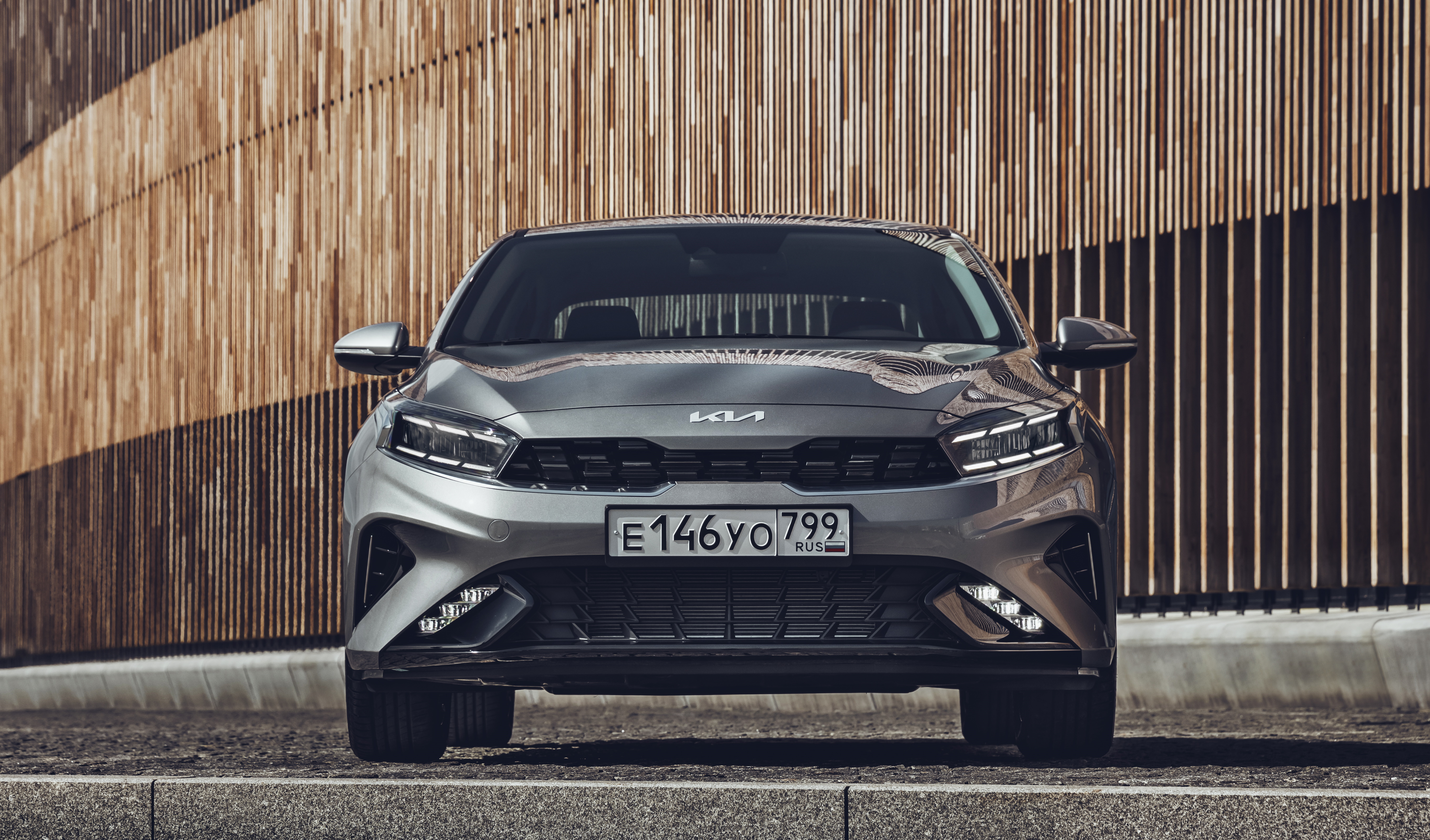 Kia Cerato parked in front of a wooden wall HD Wallpaper