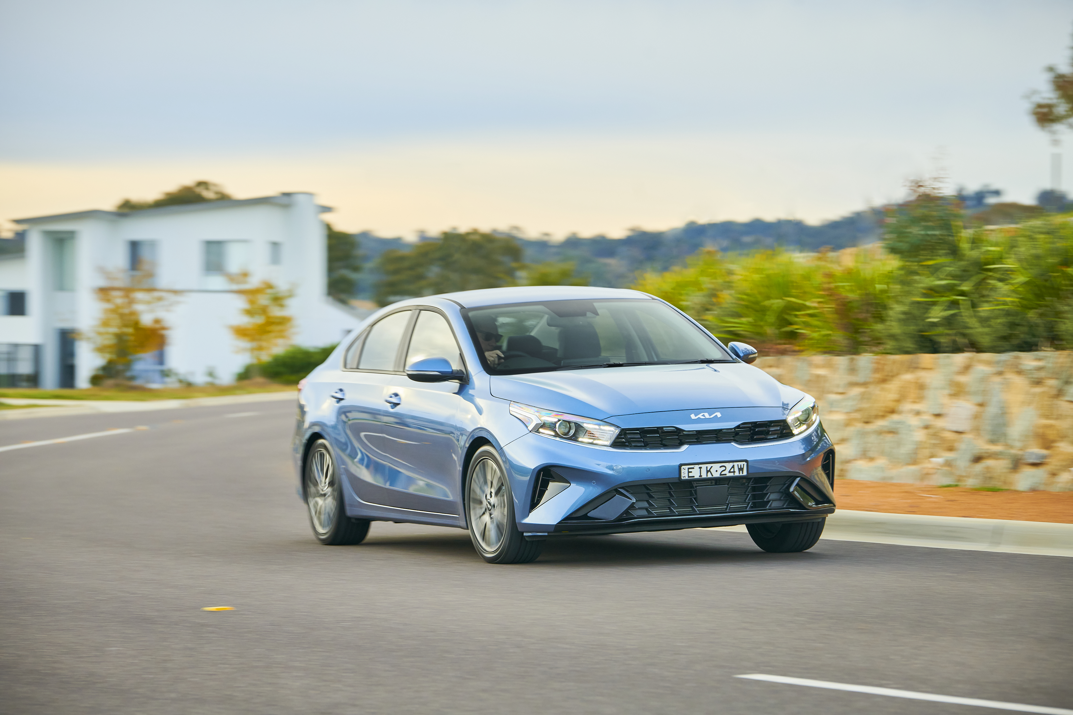 Blue Kia Cerato Sport Plus compact car driving HD Wallpaper
