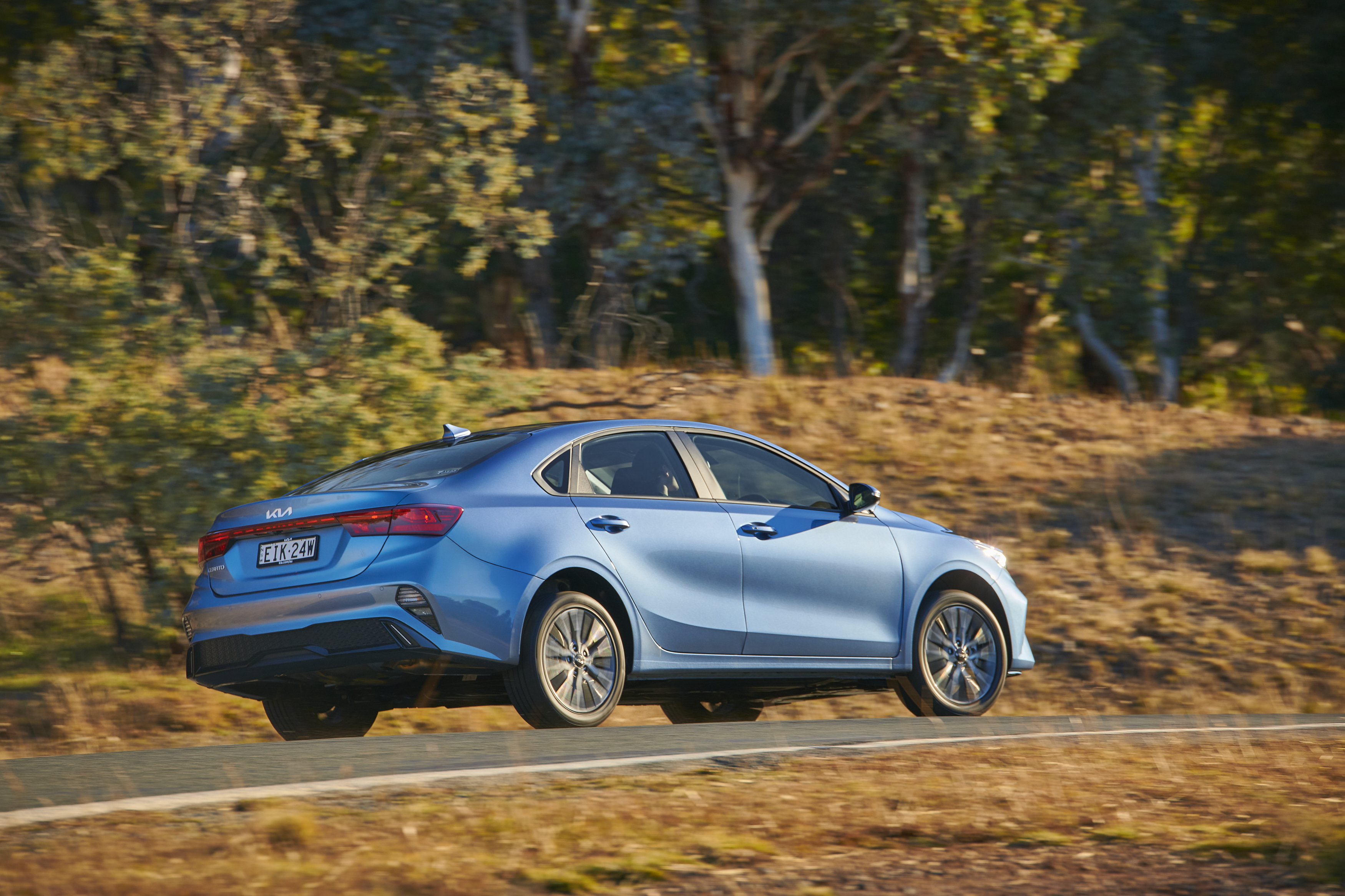 Blue Kia Cerato Sport Plus driving on a scenic road HD Wallpaper