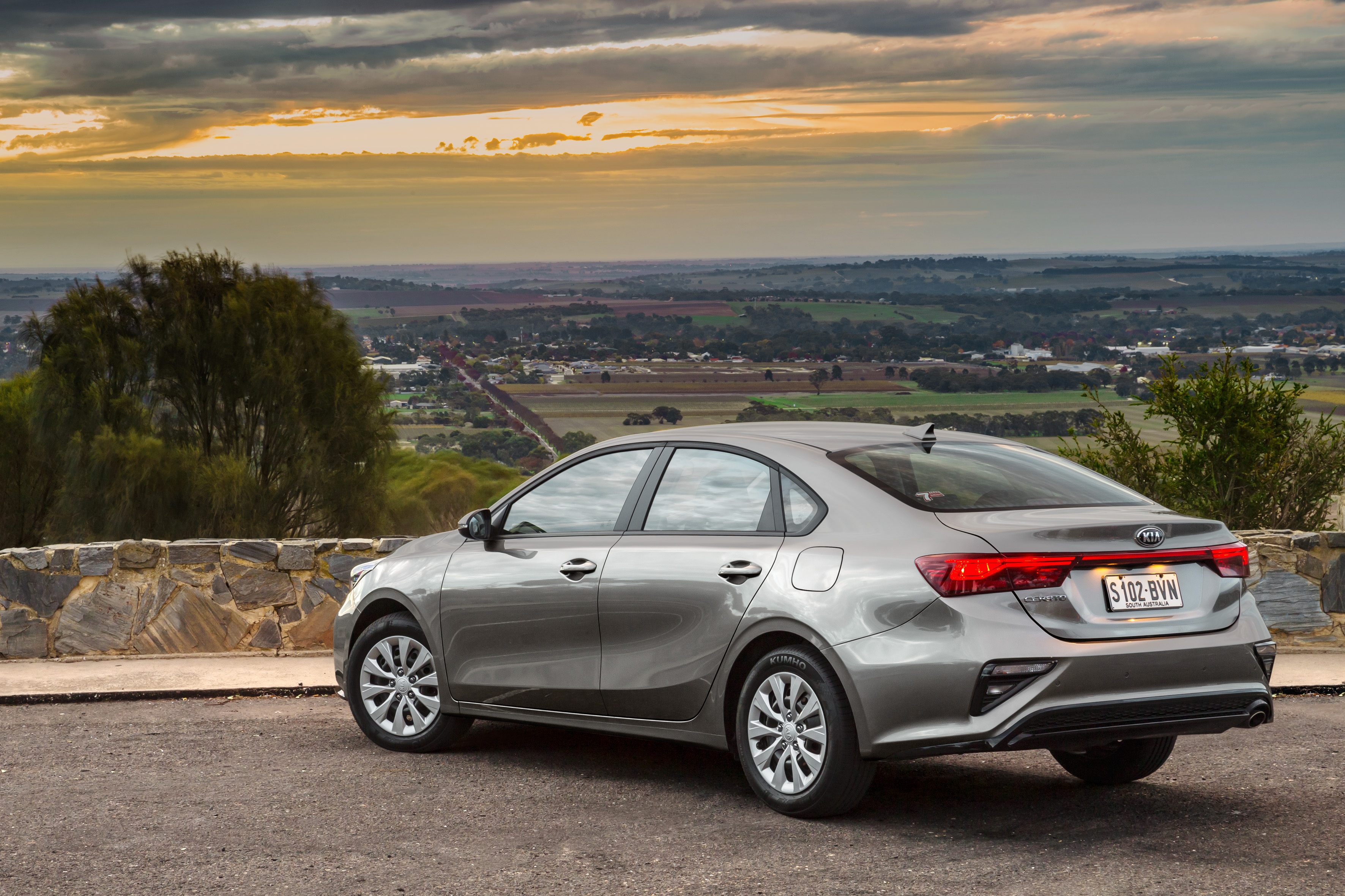 Kia Cerato S compact car with sunset valley view HD Wallpaper