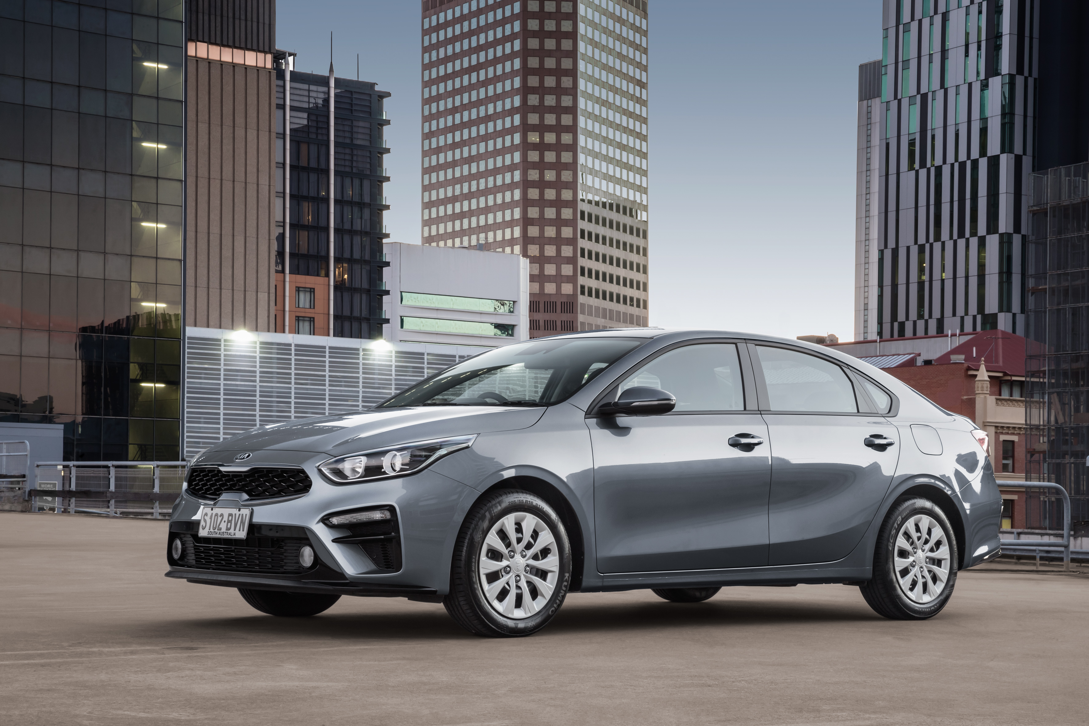Kia Cerato S sedan on city rooftop HD Wallpaper