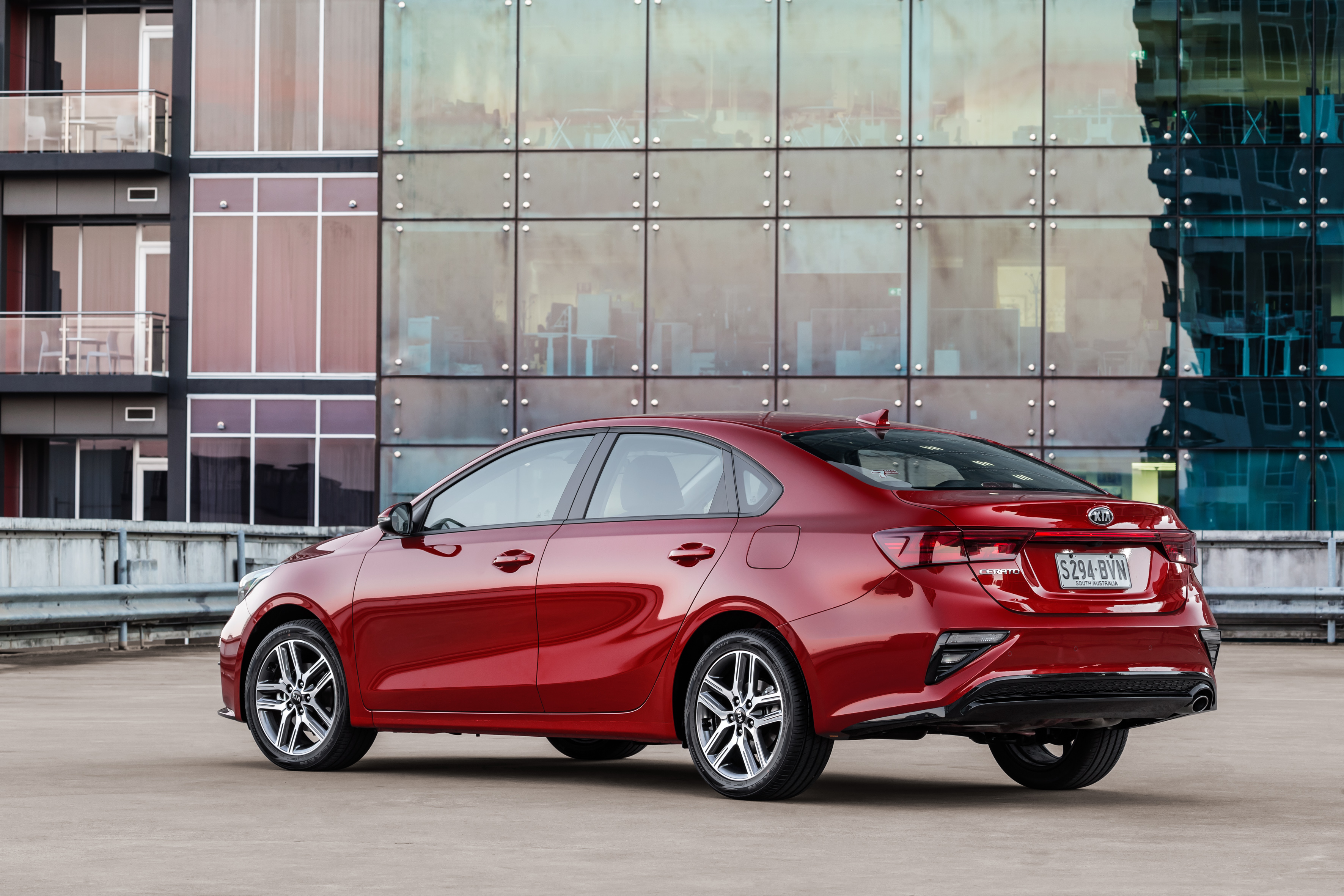 Red Kia Cerato Sport Plus parked on rooftop HD Wallpaper