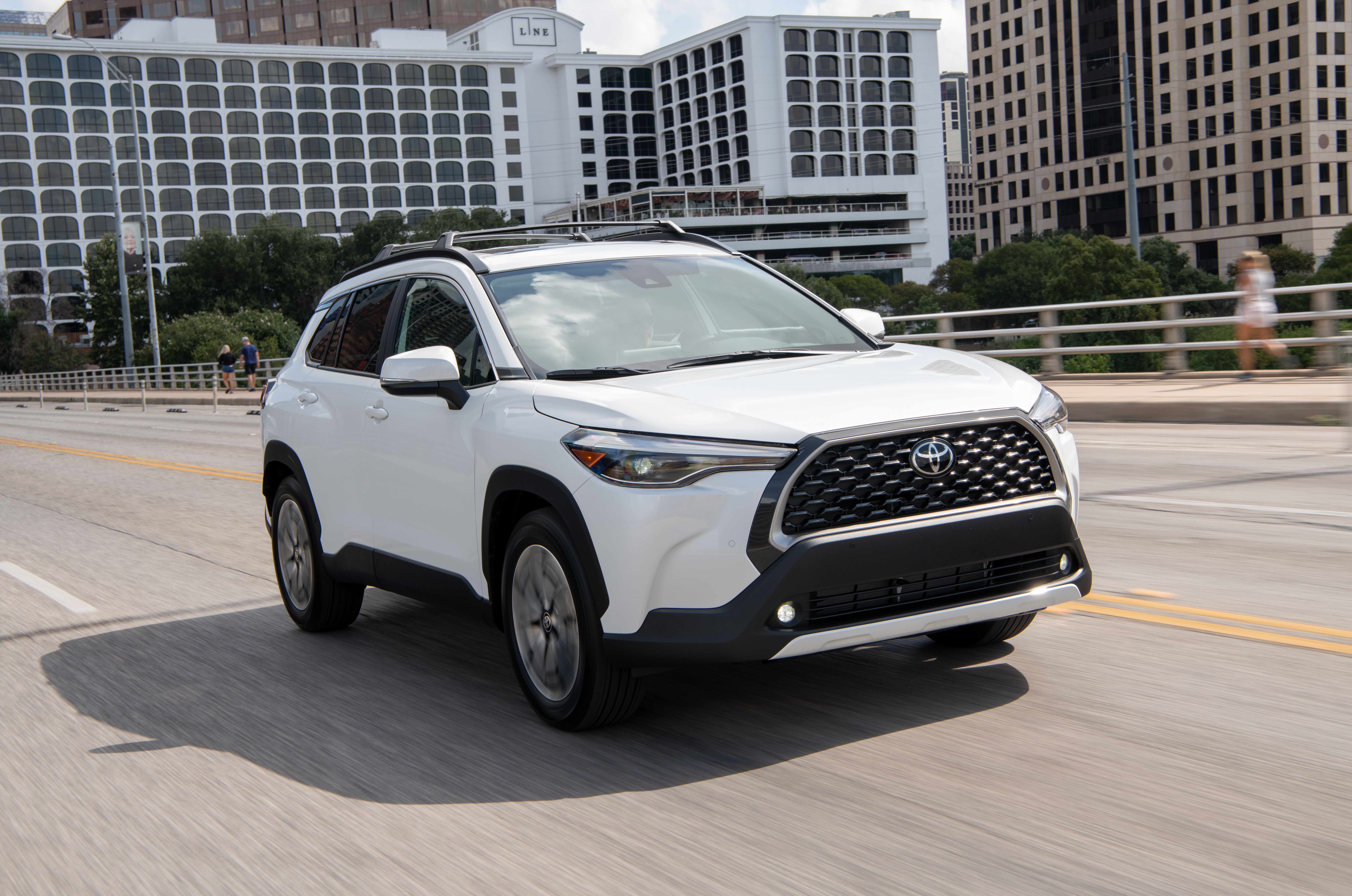 White Toyota Corolla Cross XLE SUV on road HD Wallpaper
