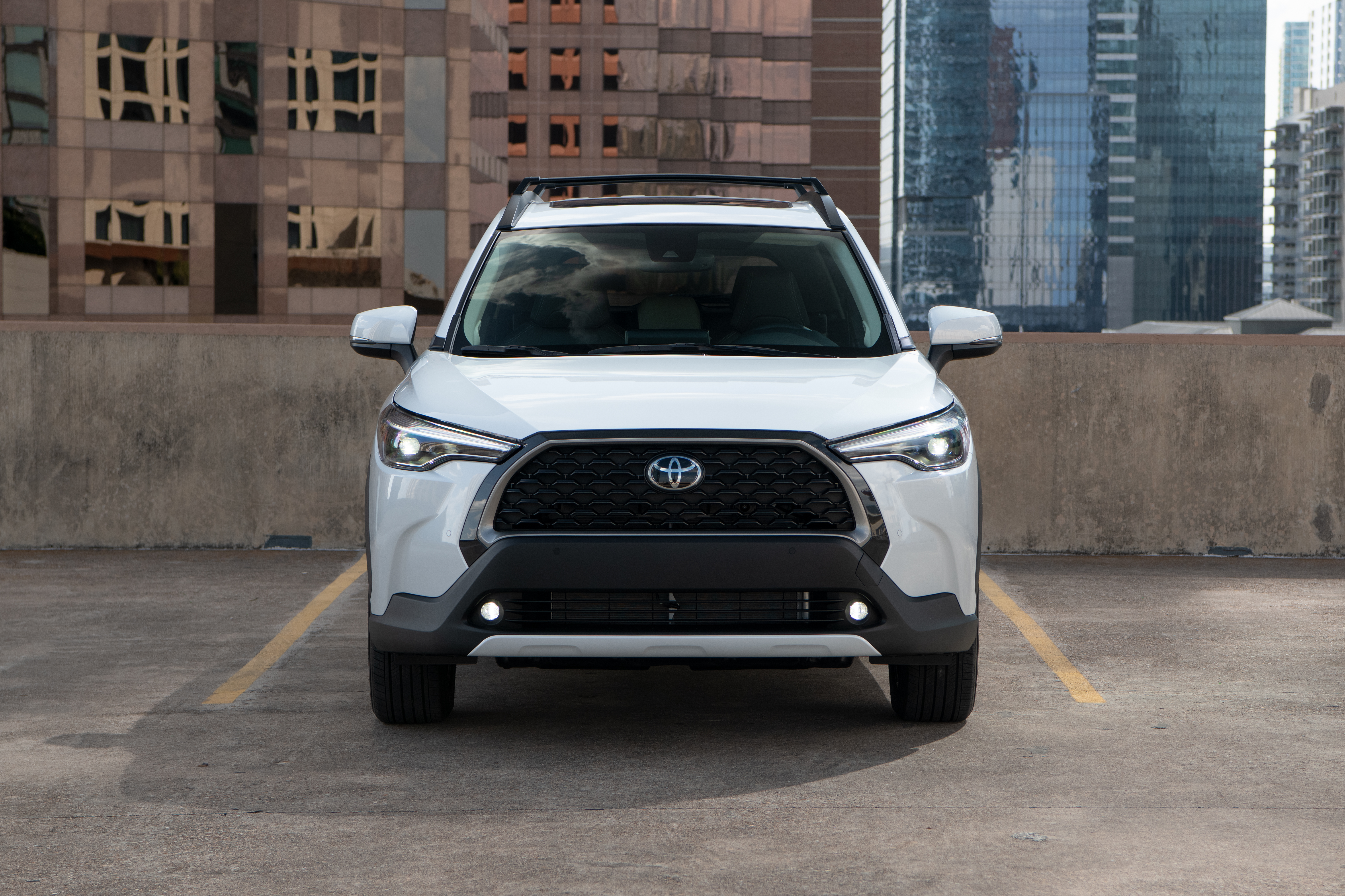 White Toyota Corolla Cross 4K SUV in city HD Wallpaper