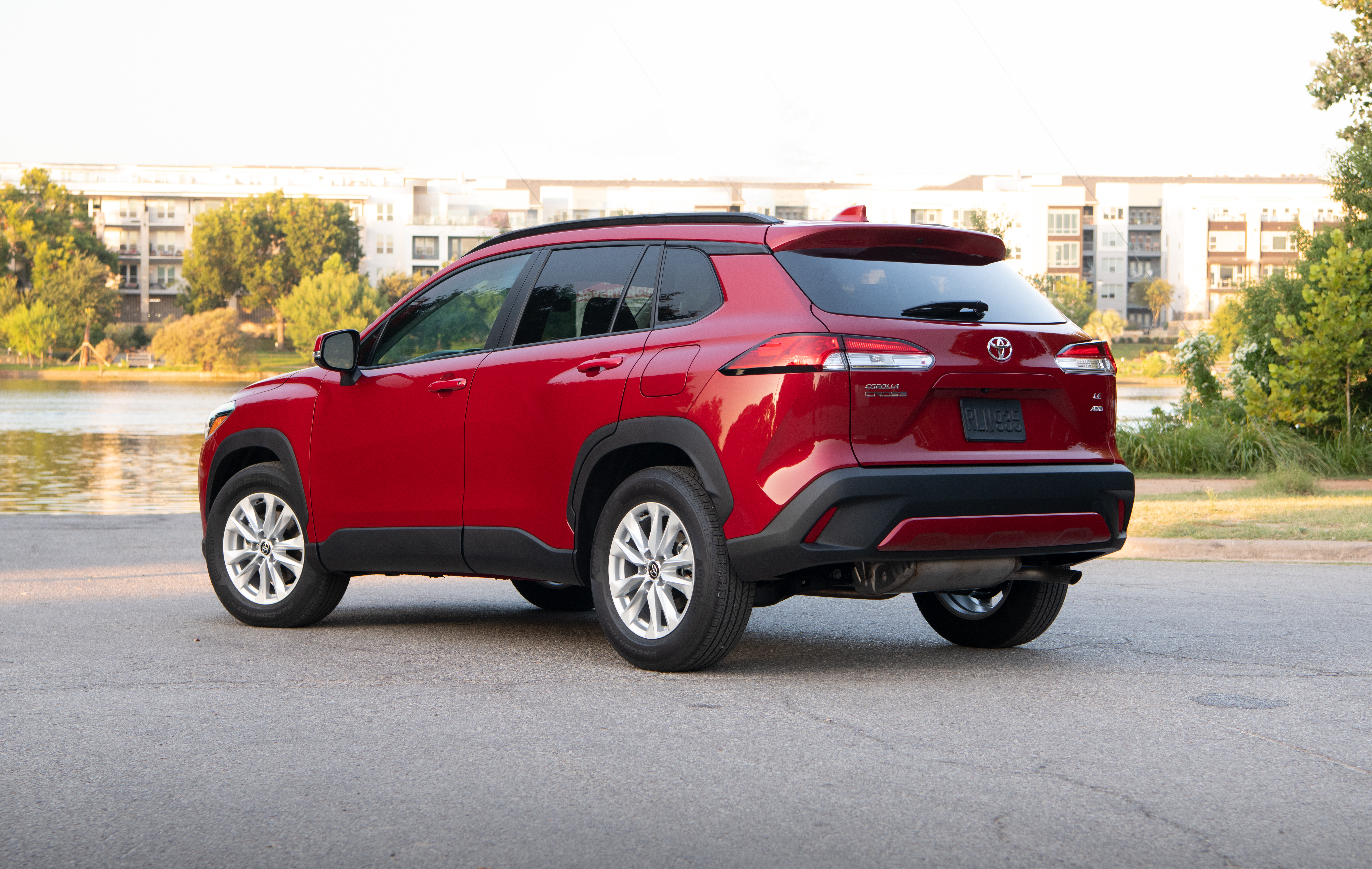 Red Toyota Corolla Cross SUV parked by water HD Wallpaper