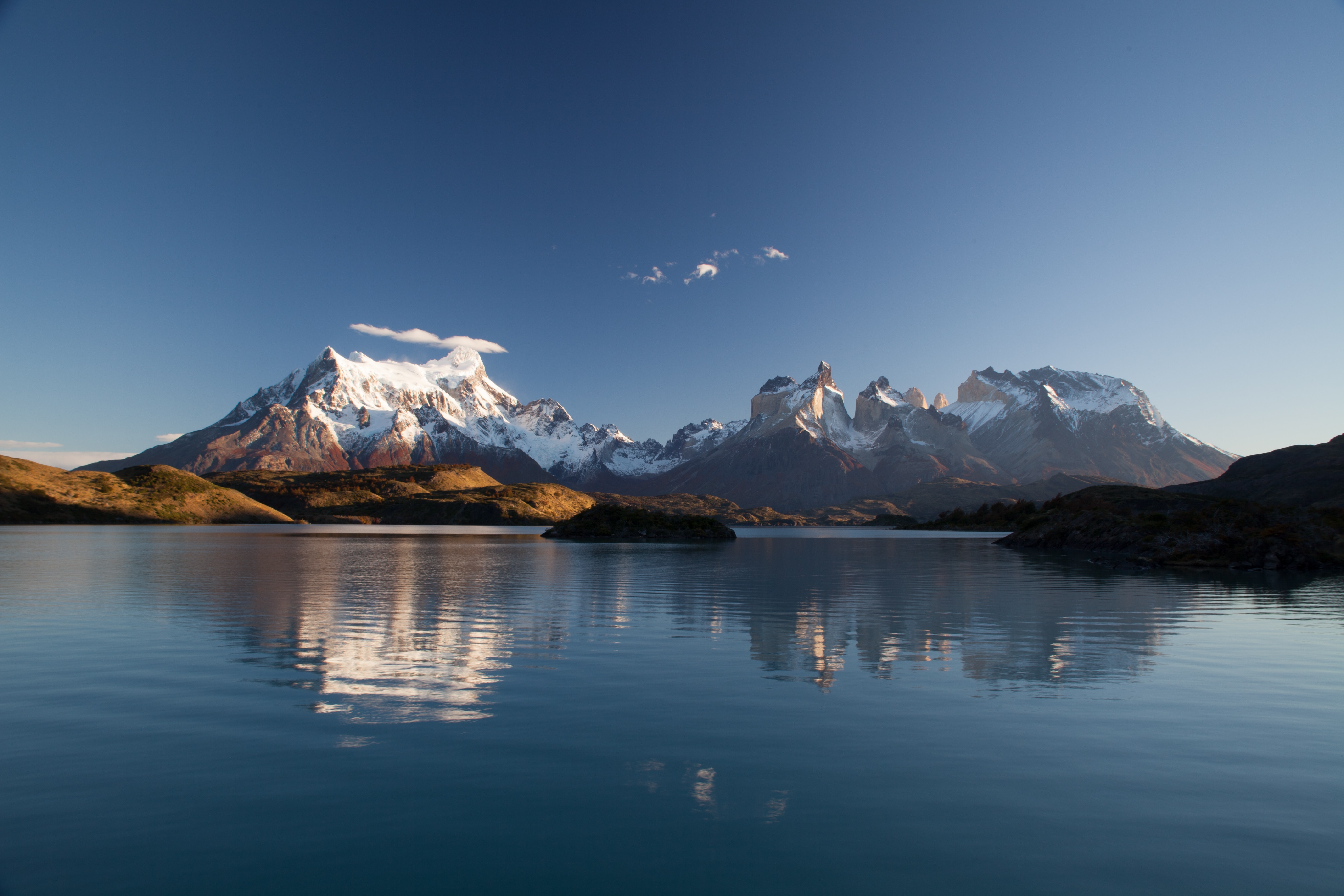 Snow-capped mountains reflected in Torres Del Paine lake HD Wallpaper