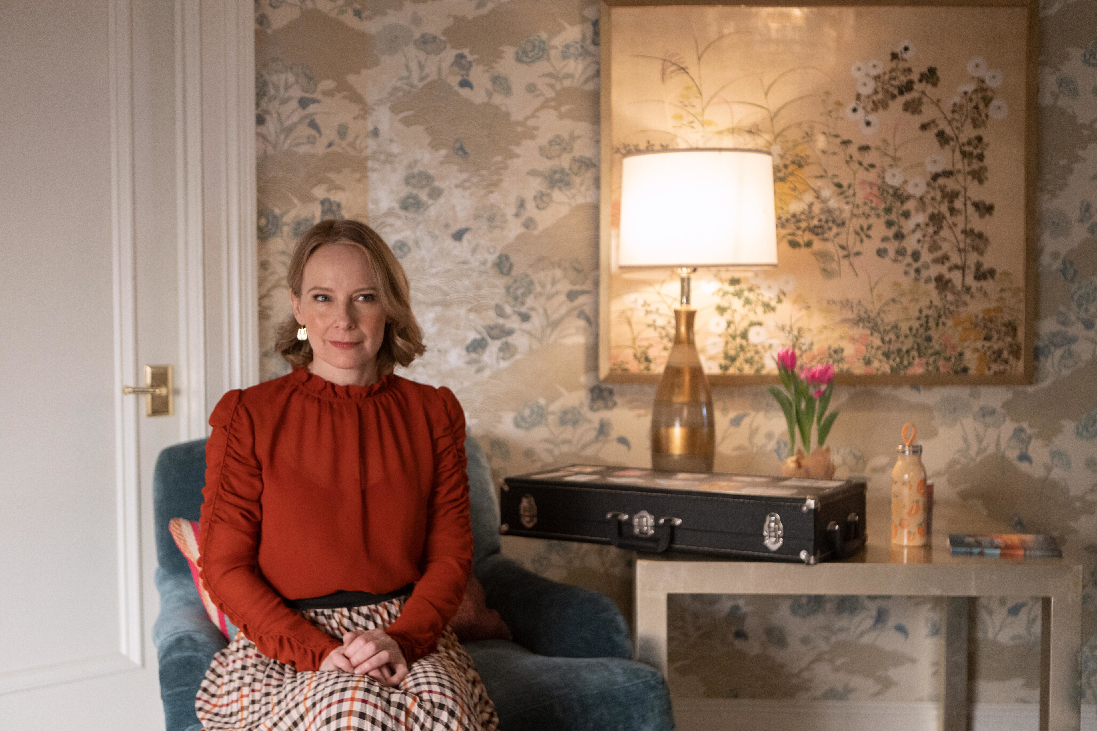 Amy Ryan in a red blouse and plaid skirt HD Wallpaper