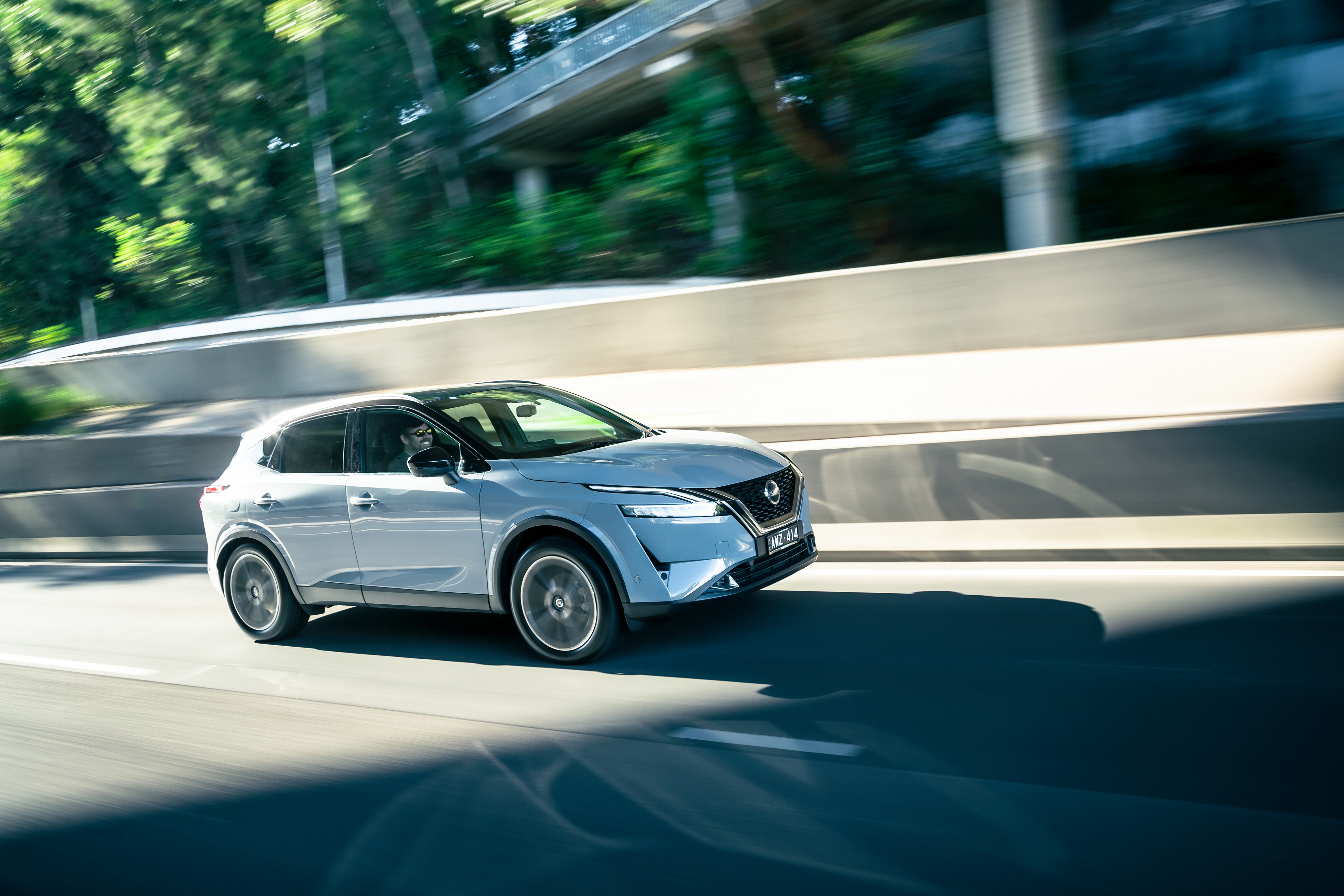 Nissan Qashqai SUV in motion on road HD Wallpaper