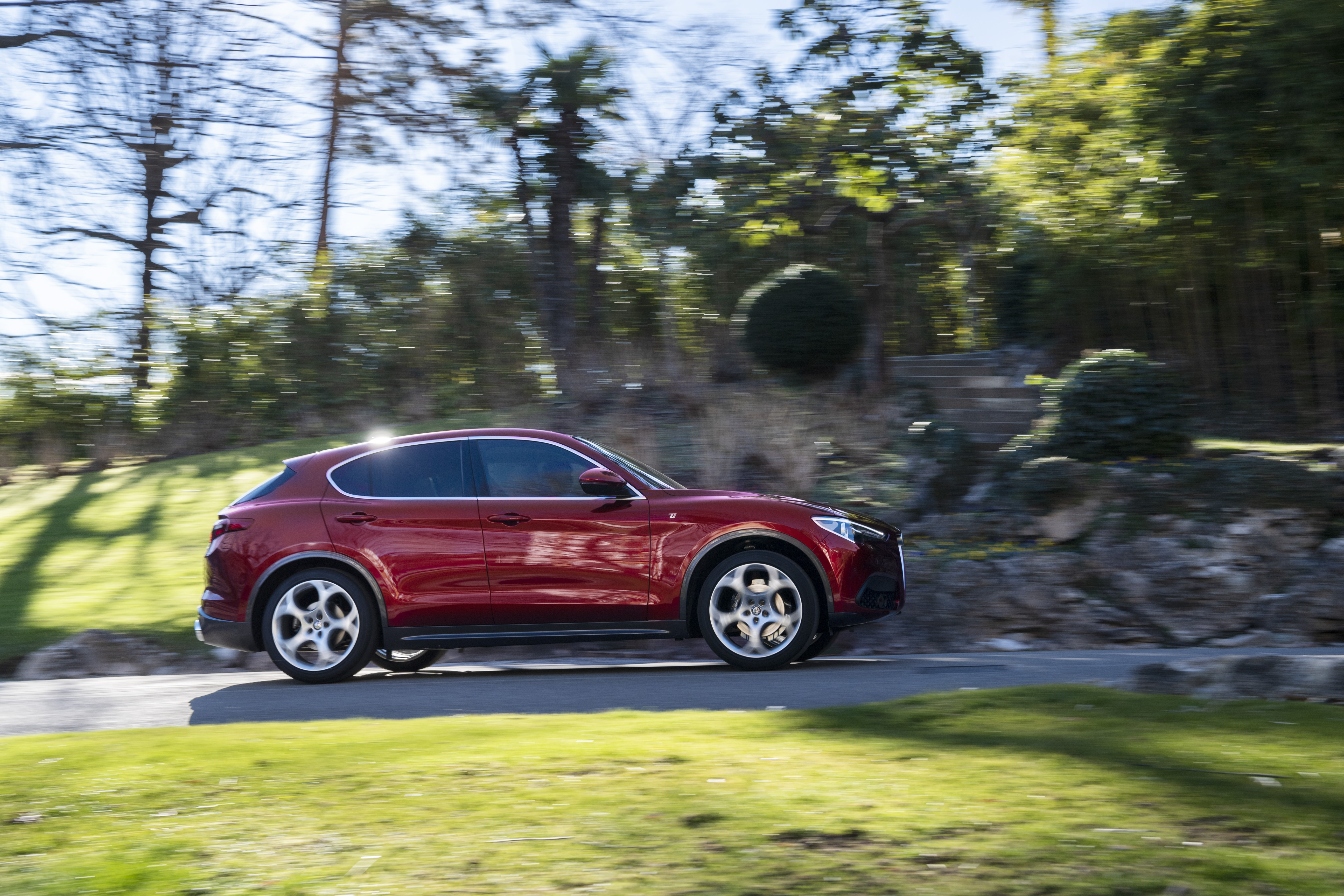 Red Alfa Romeo Stelvio SUV in motion HD Wallpaper
