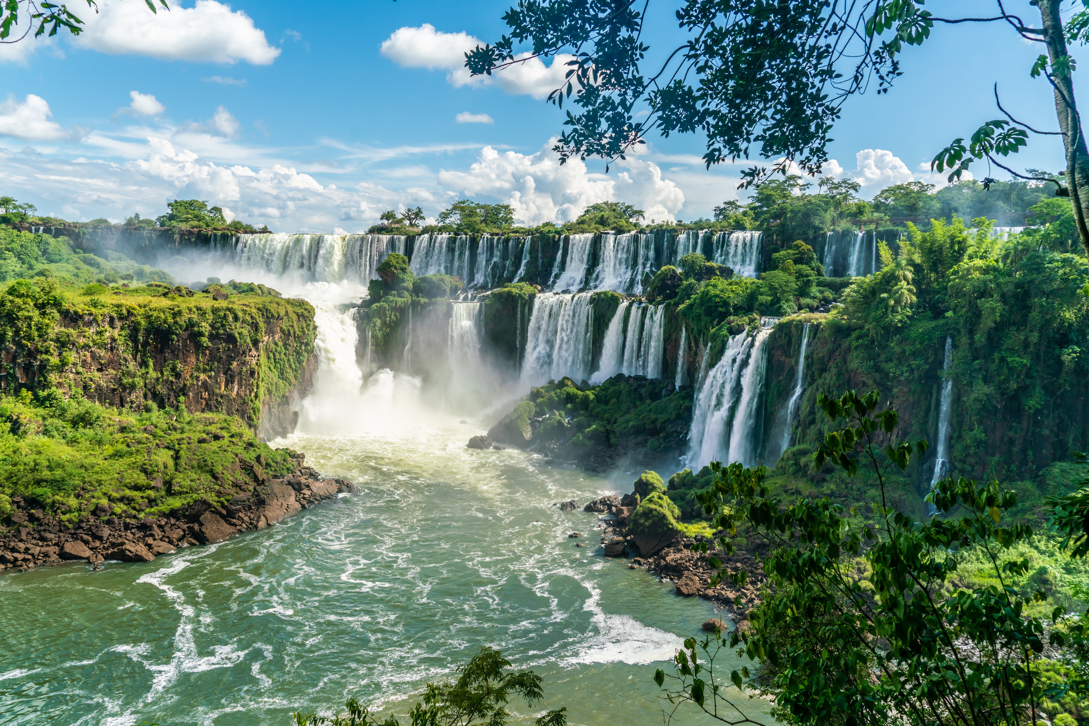 Majestic waterfalls in a vibrant green tropical landscape HD Wallpaper