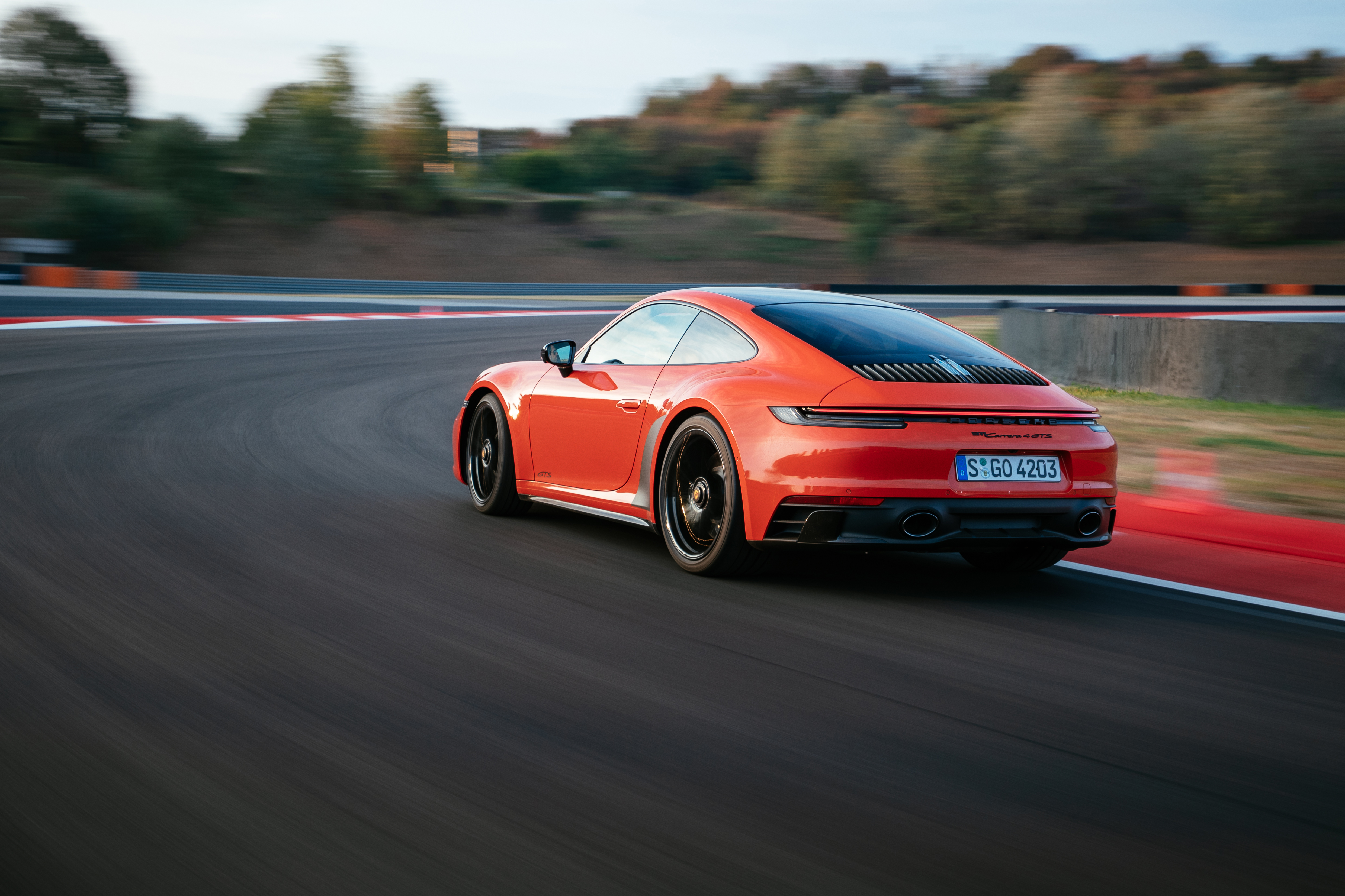 Porsche 911 Carrera GTS cornering on a race track HD Wallpaper