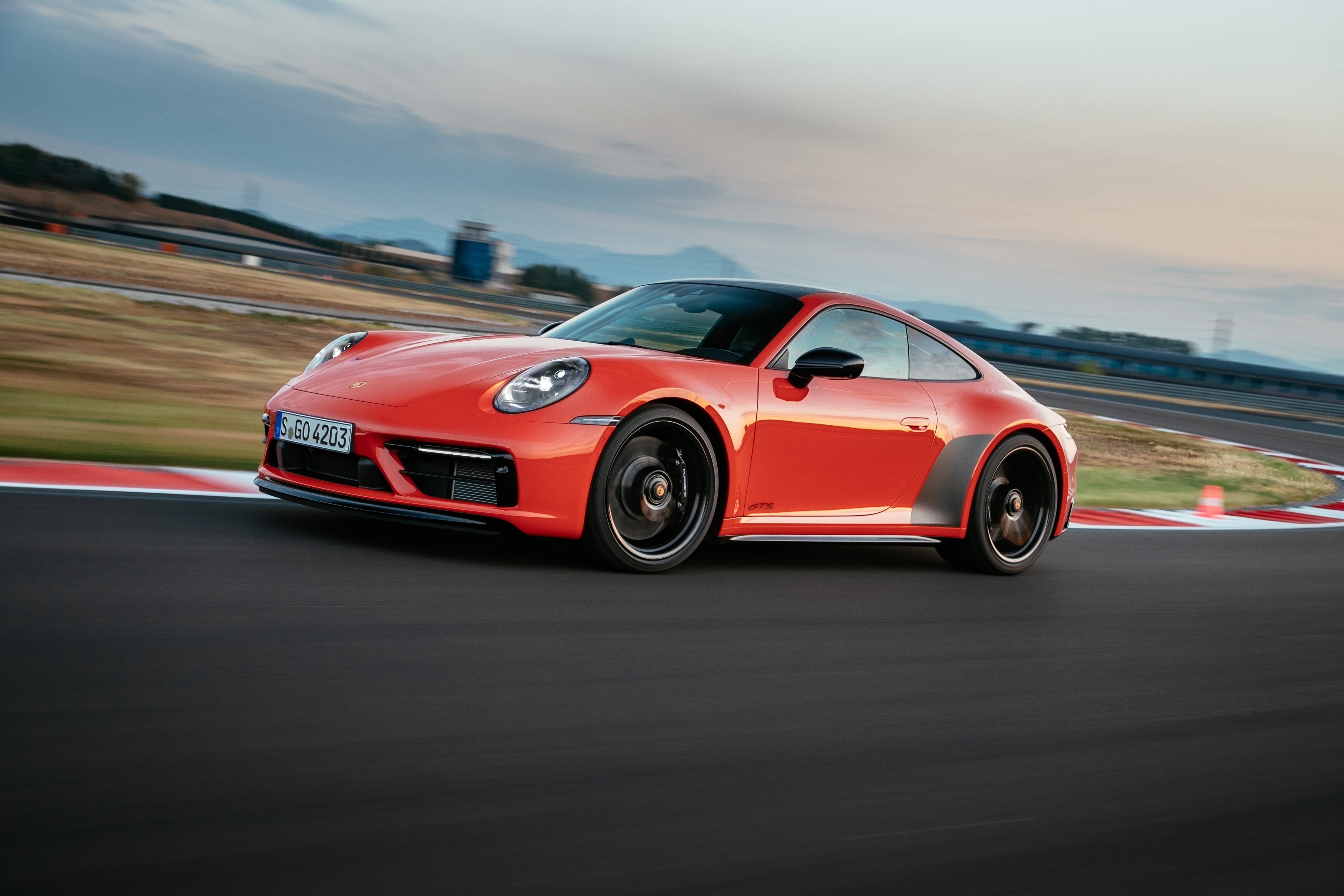 Red Porsche 911 Carrera GTS on race track HD Wallpaper