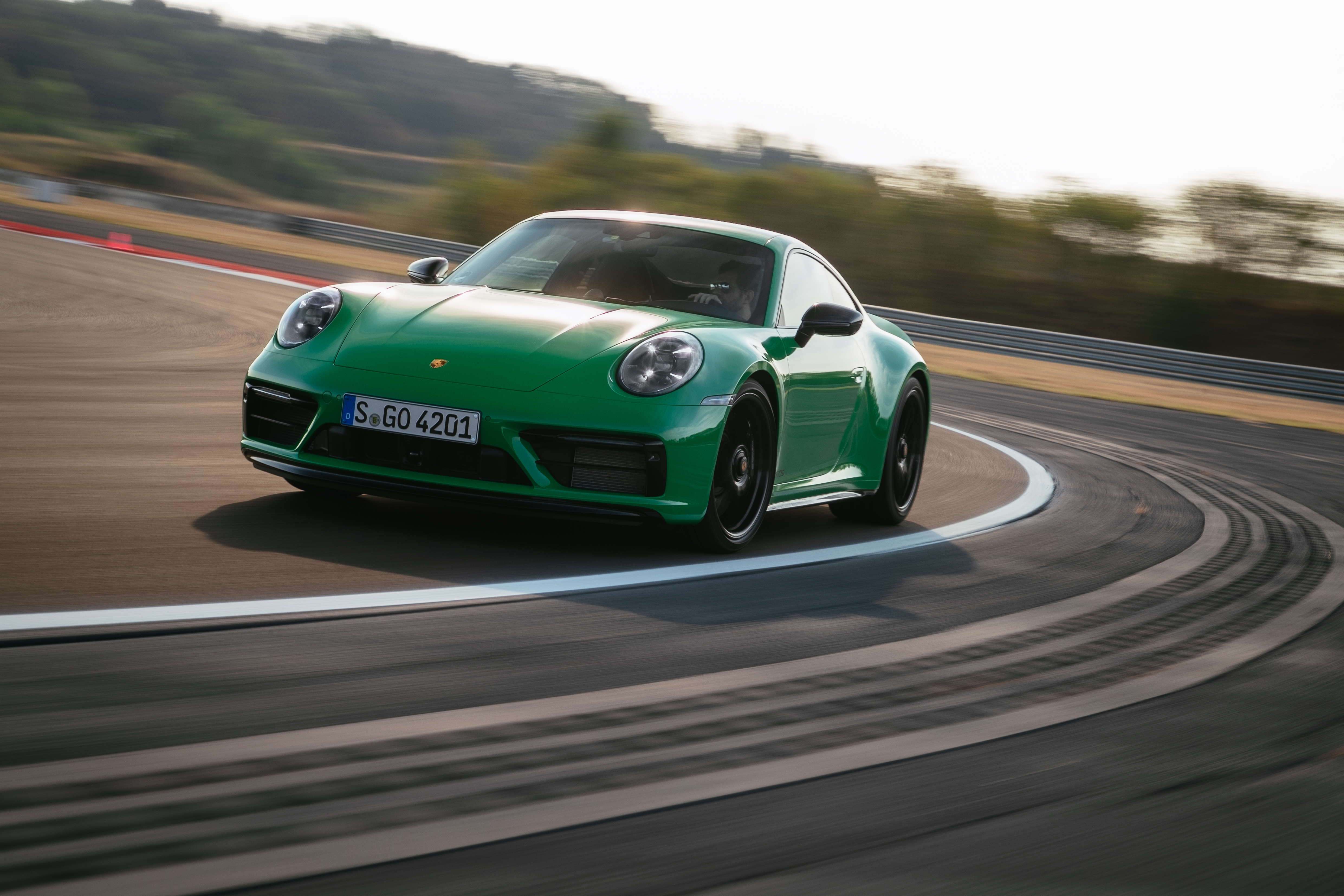 Green Porsche 911 Carrera GTS cornering on track HD Wallpaper