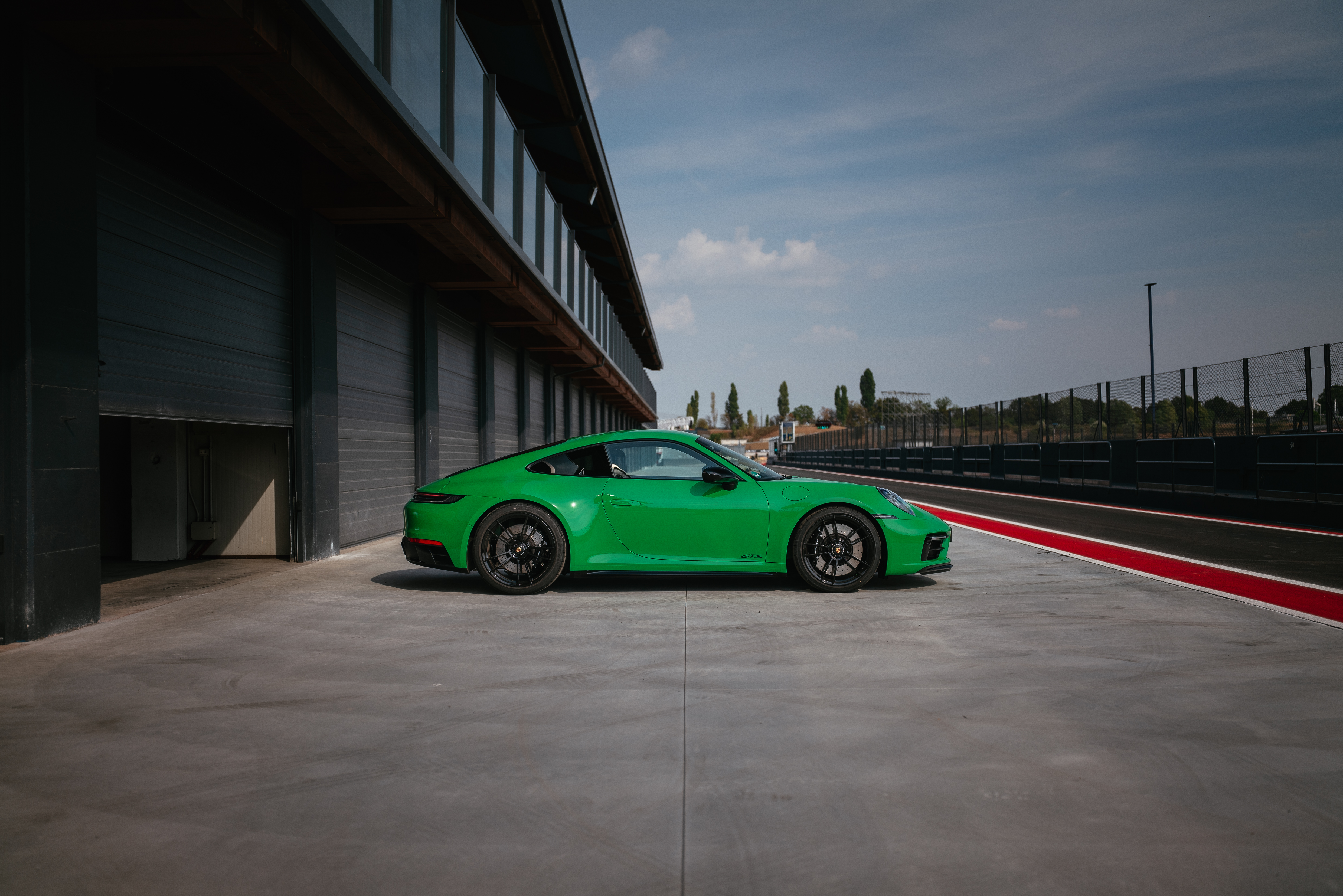 Green Porsche 911 Carrera GTS at the track HD Wallpaper